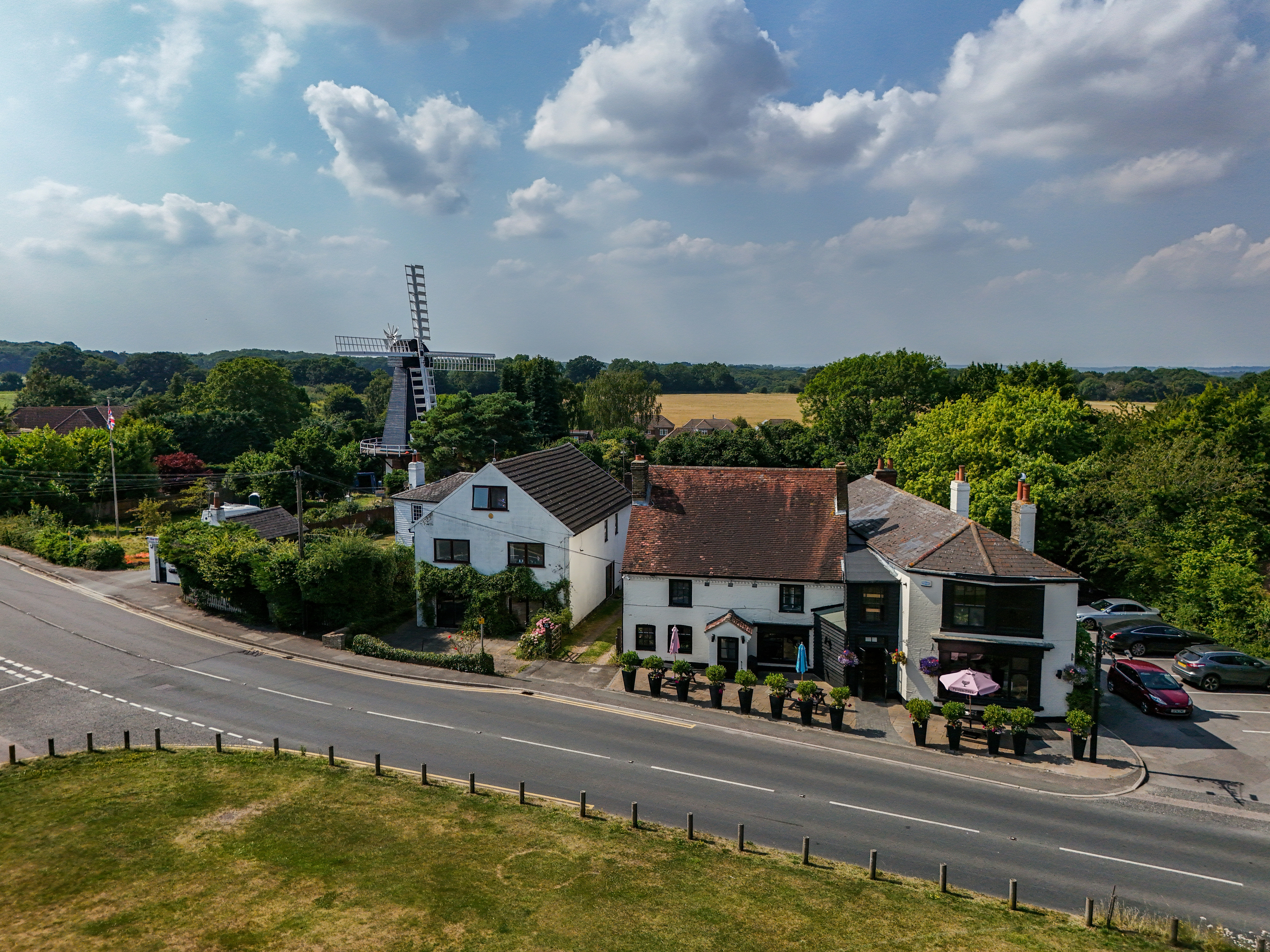 An aerial view of a town with a windmill in the background