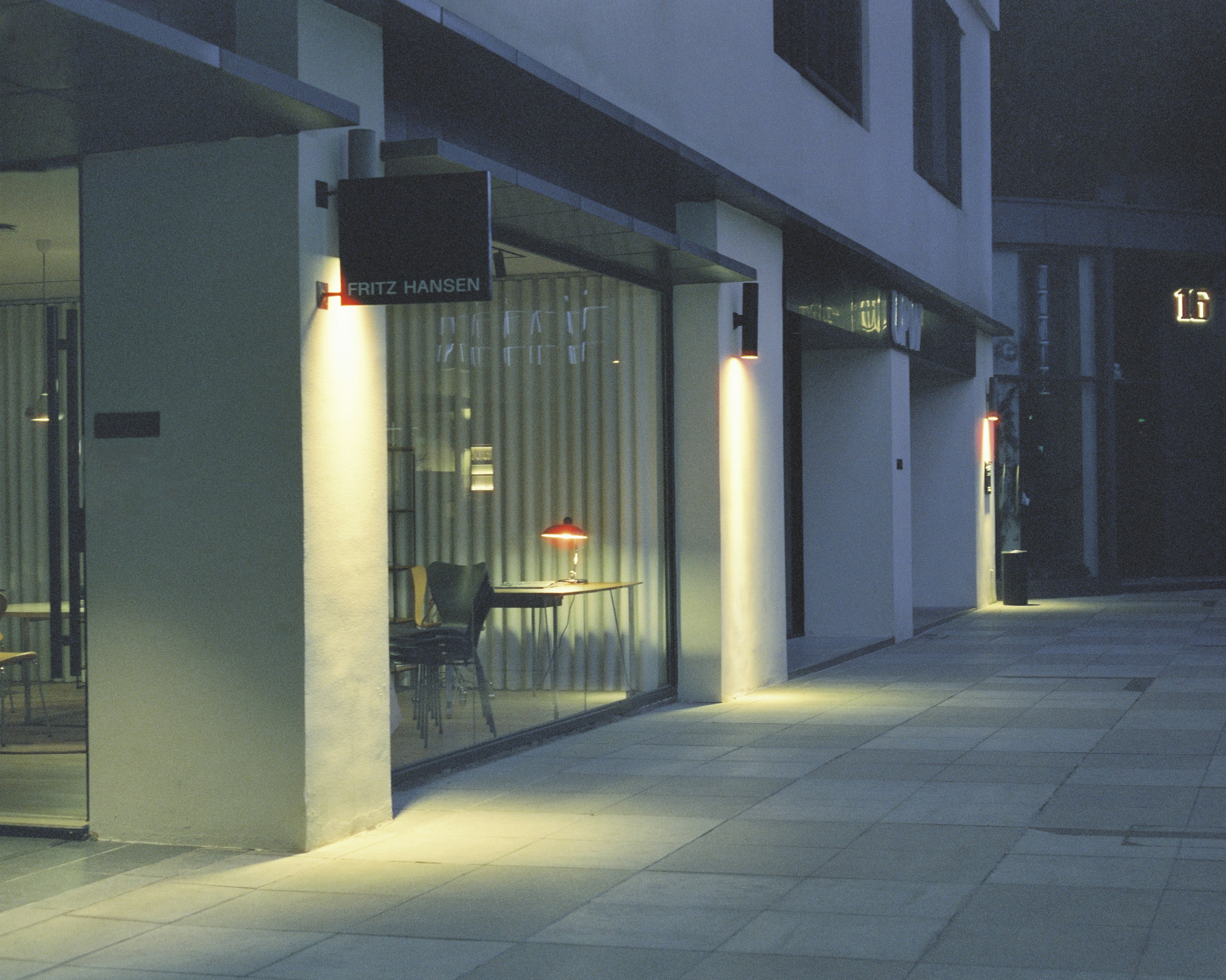 Illuminated commercial exterior sign on a business building at dusk