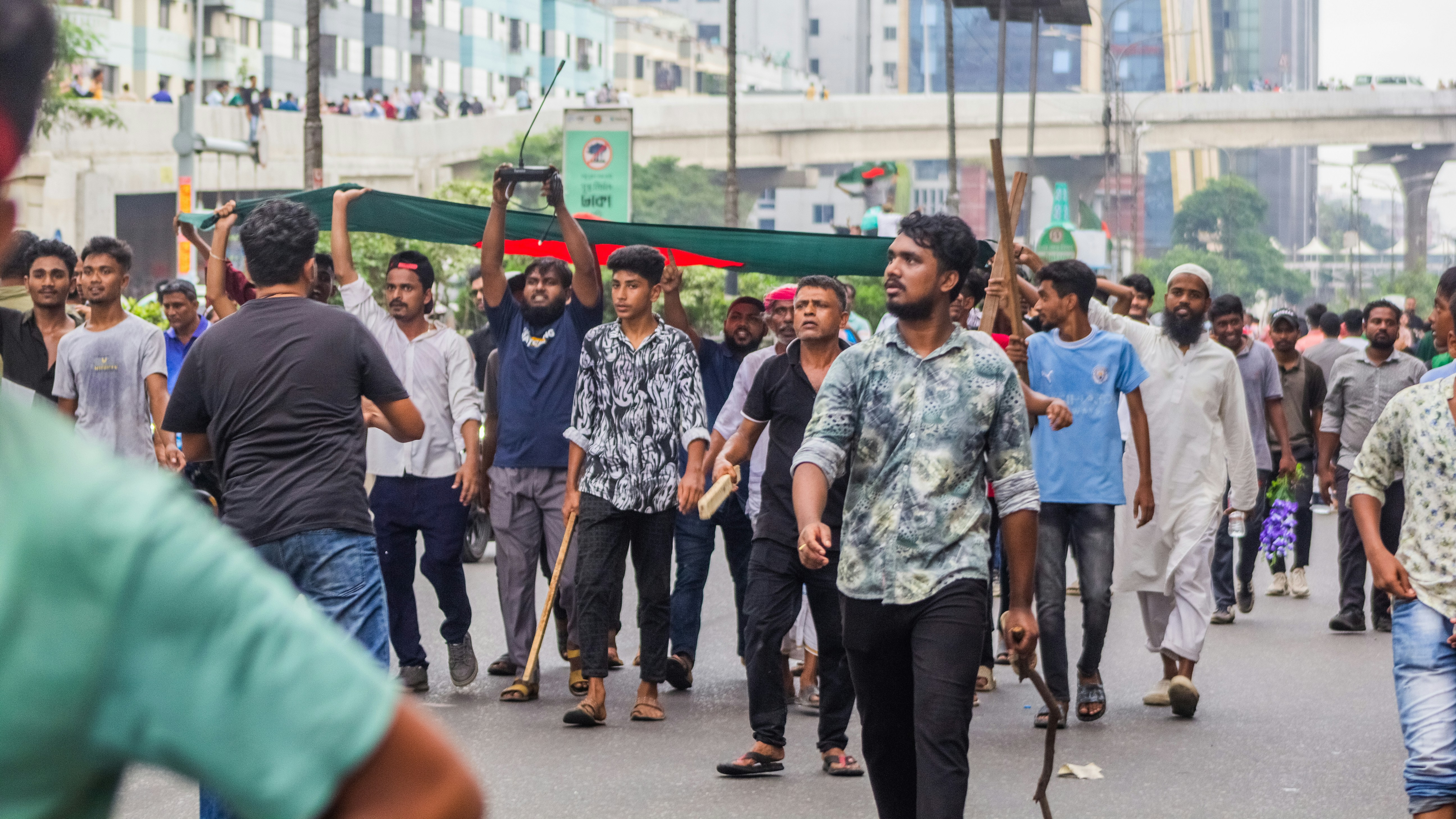 A crowd of people walking down a street