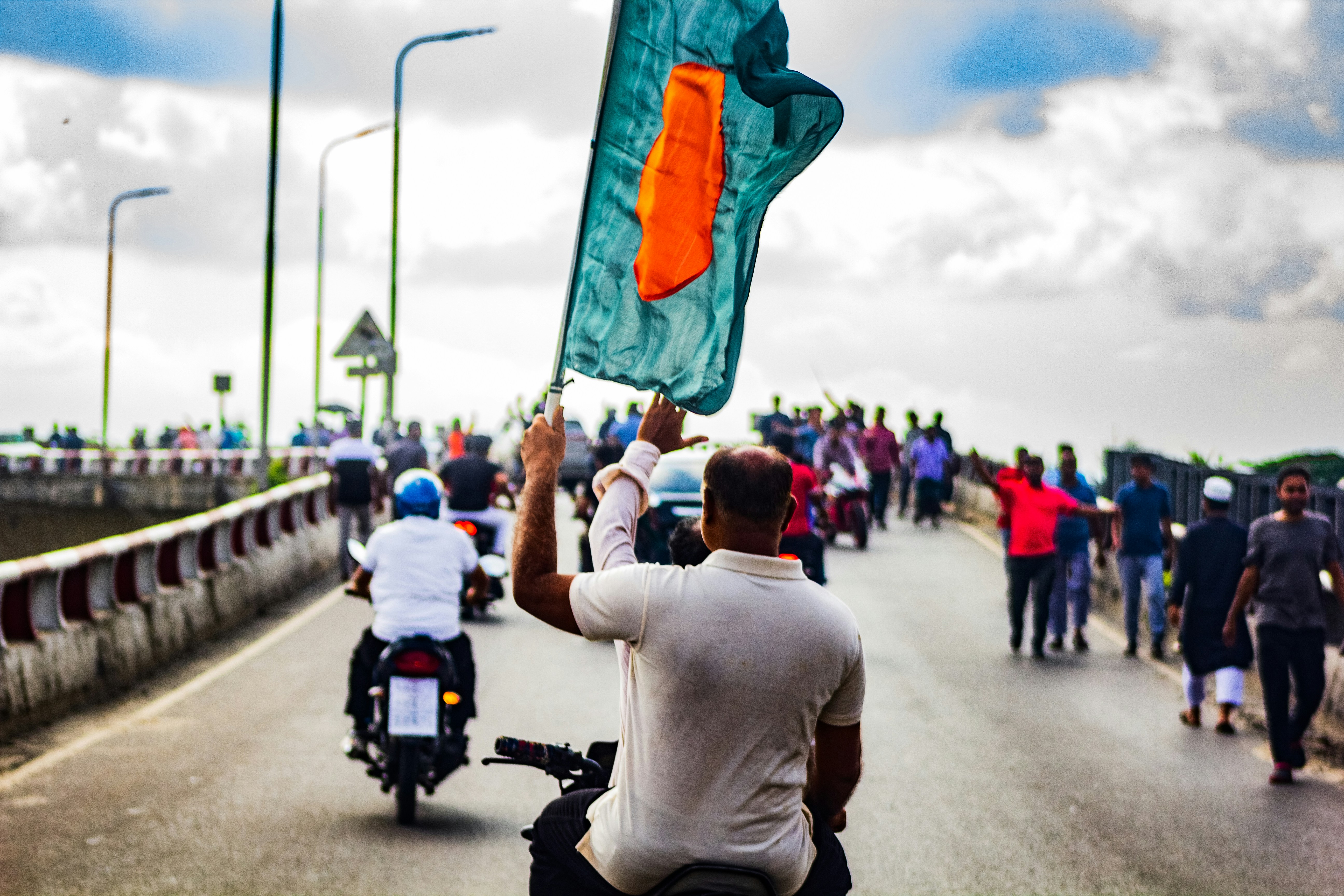 A group of people riding motorcycles down a road