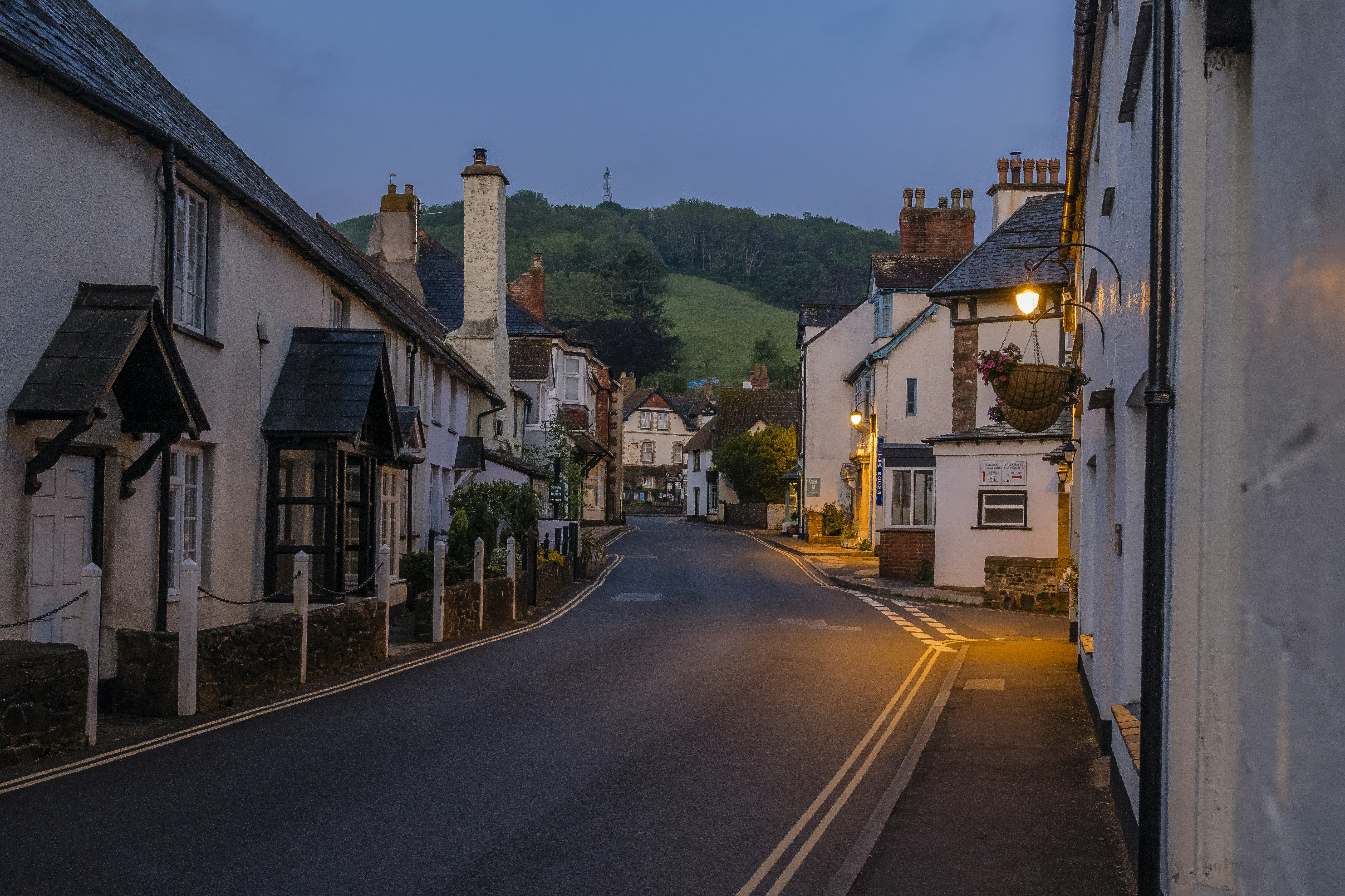 A narrow street in a small town at dusk