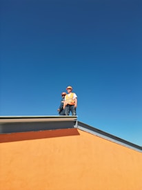 A man standing on top of a skateboard ramp