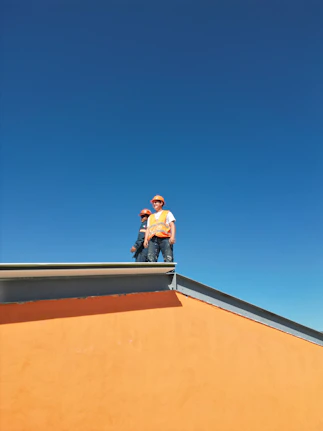 A man standing on top of a skateboard ramp