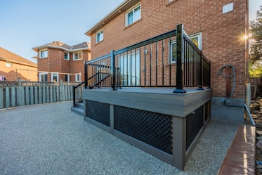 A large hot tub sitting next to a brick building