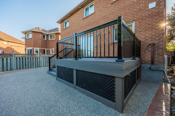 A large hot tub sitting next to a brick building