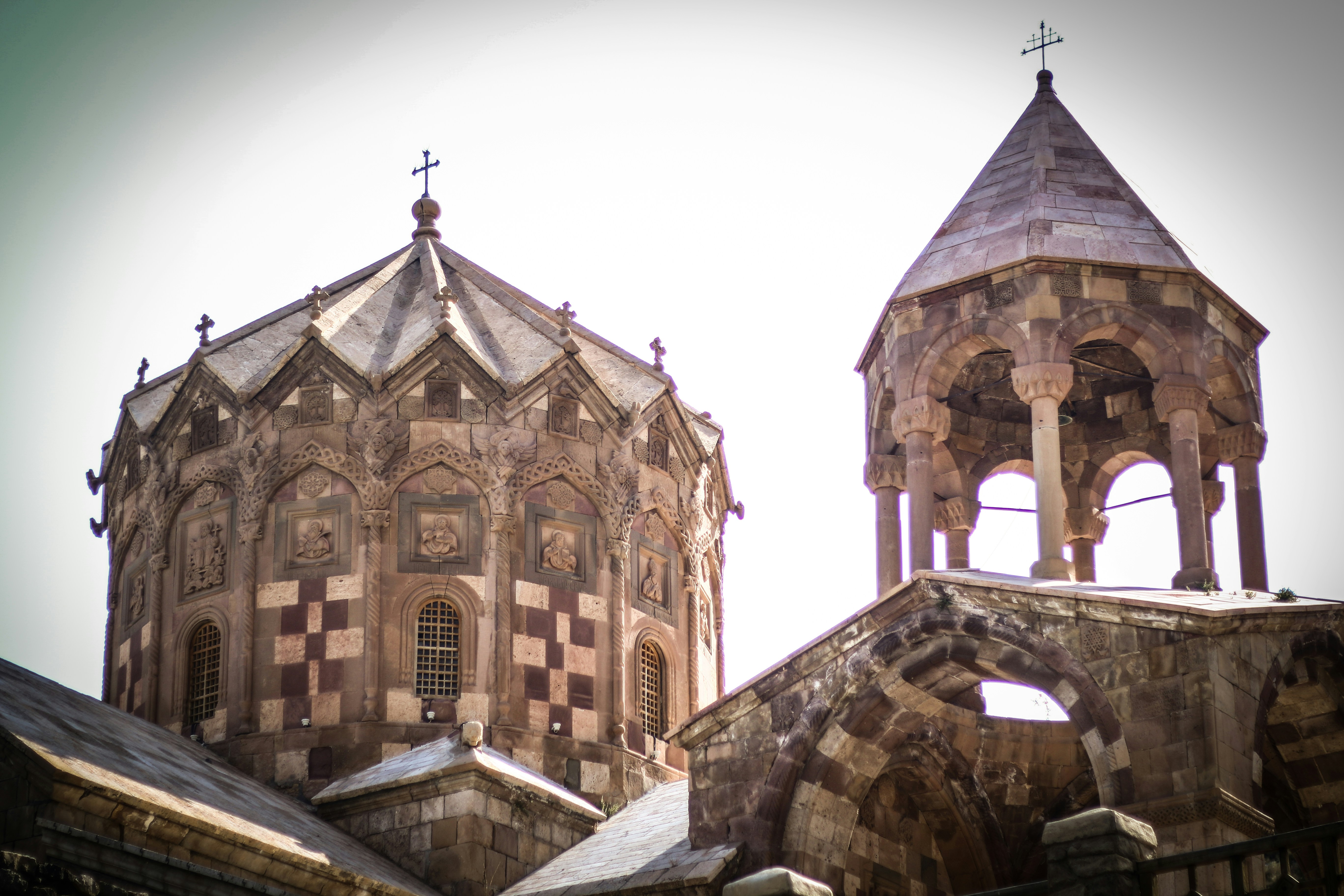An old building with two towers and a cross on top