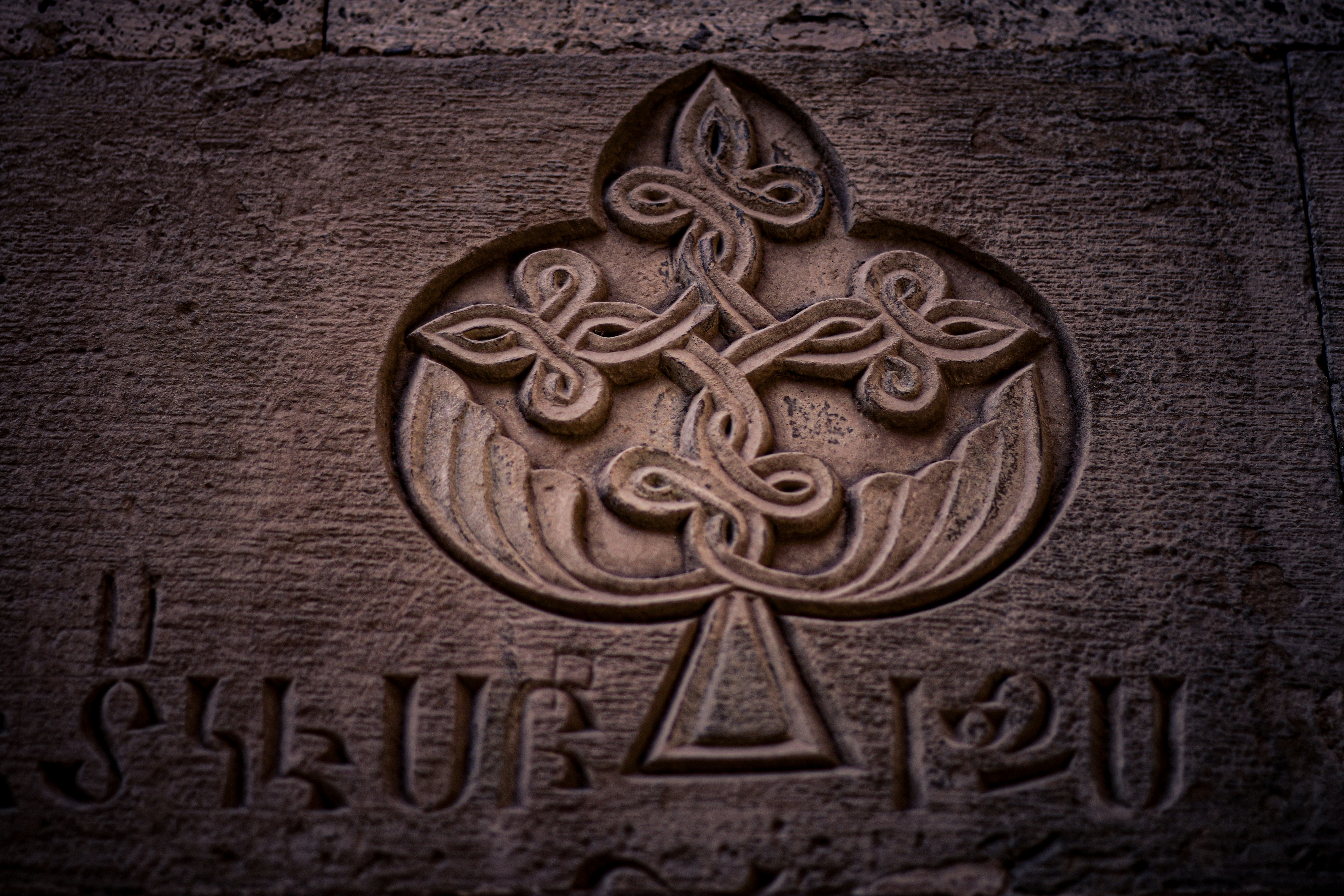 A close up of a stone with a cross on it