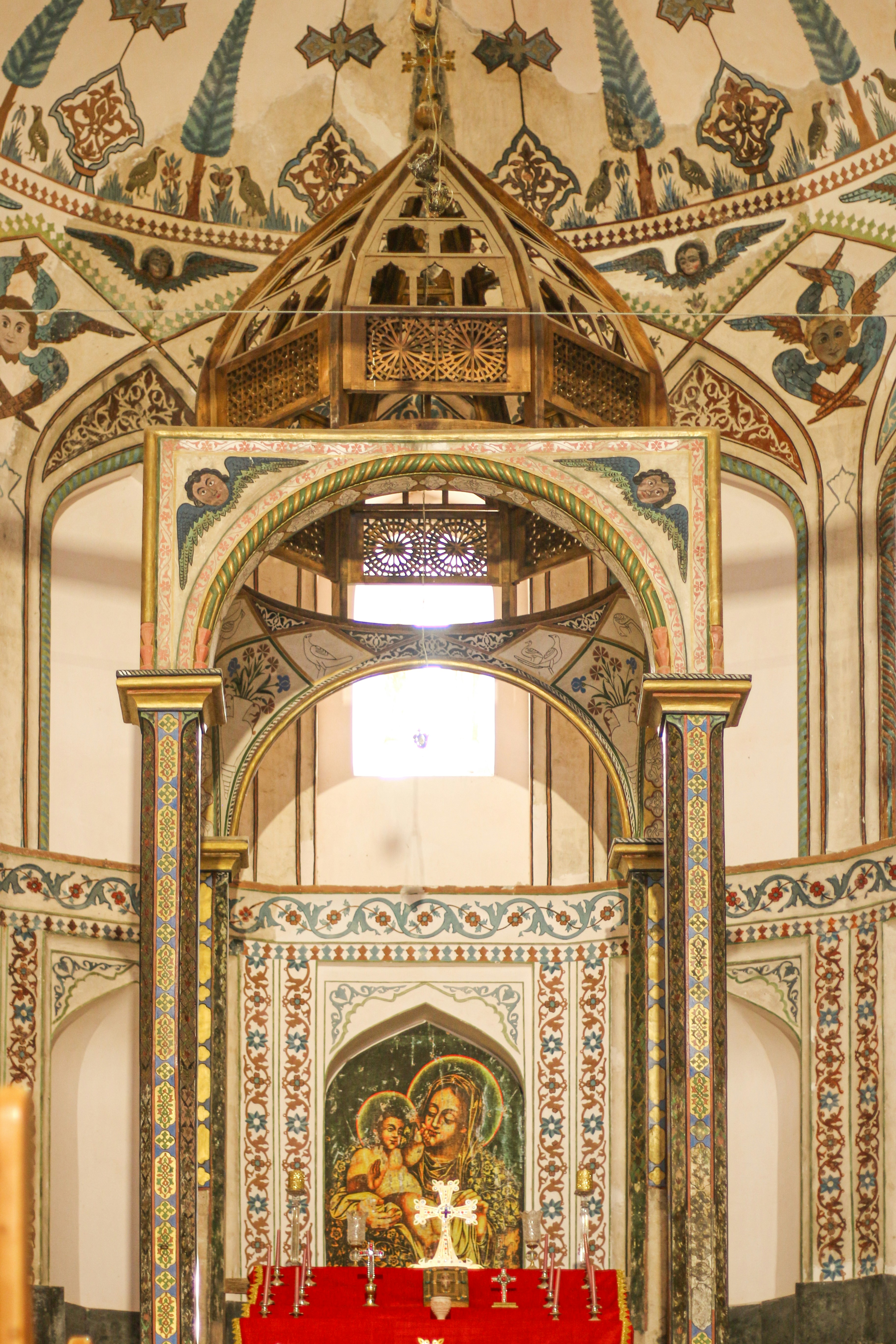 The interior of a church with a red alter