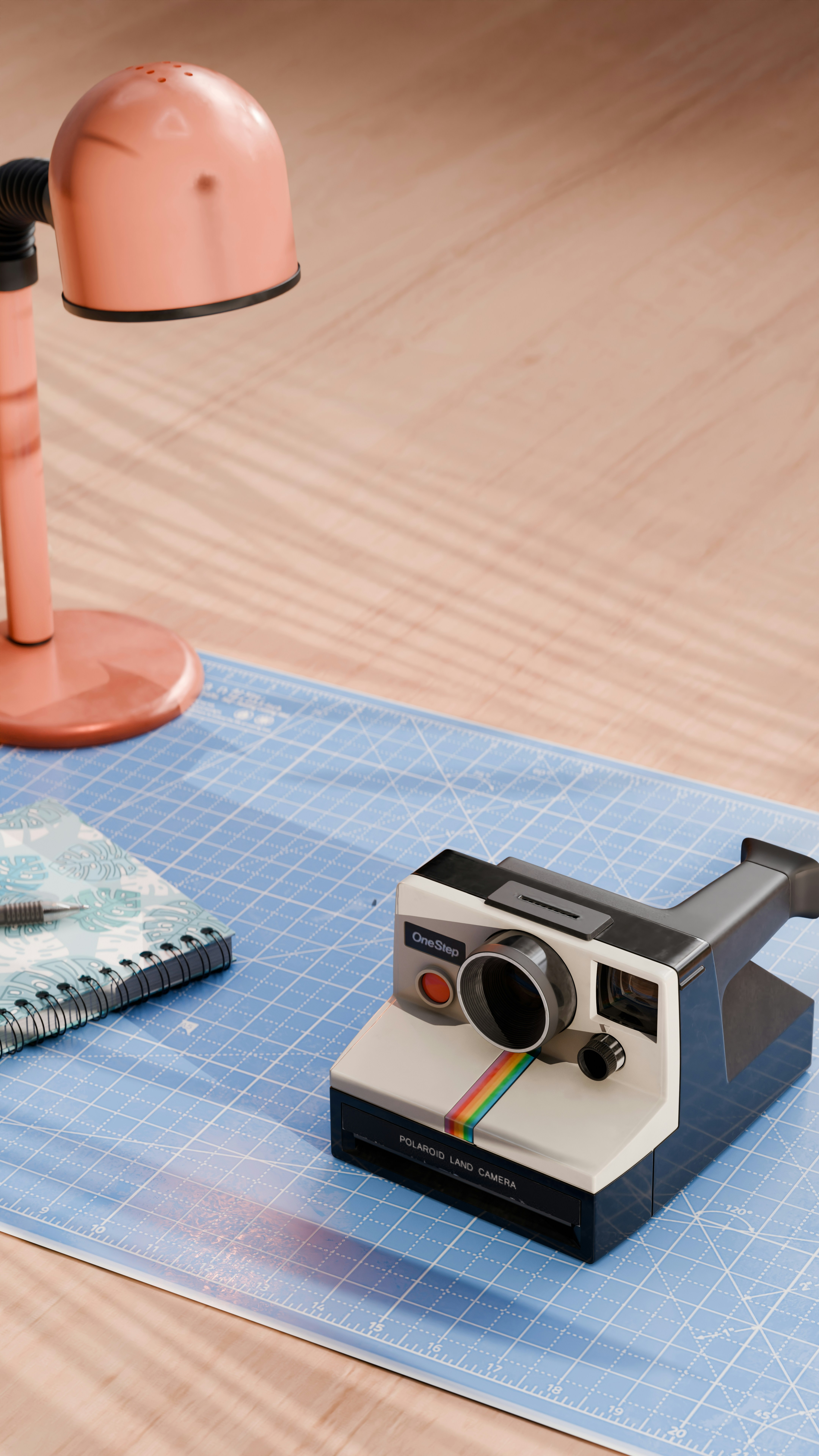 A polaroid camera sitting on top of a blue mat