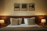 A bed with two lamps on either side of it