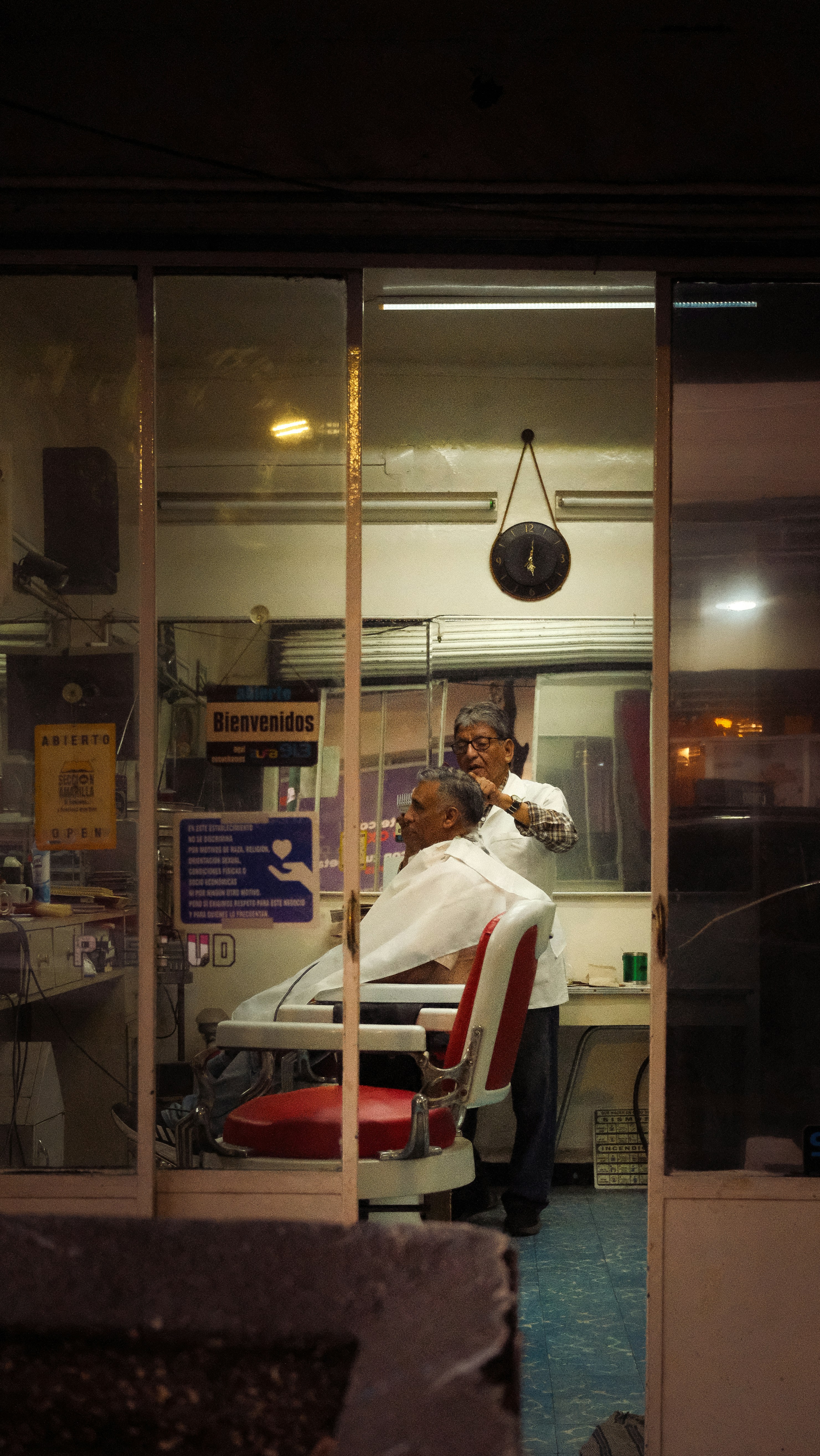 Barber shop with a barber cutting a customer's hair