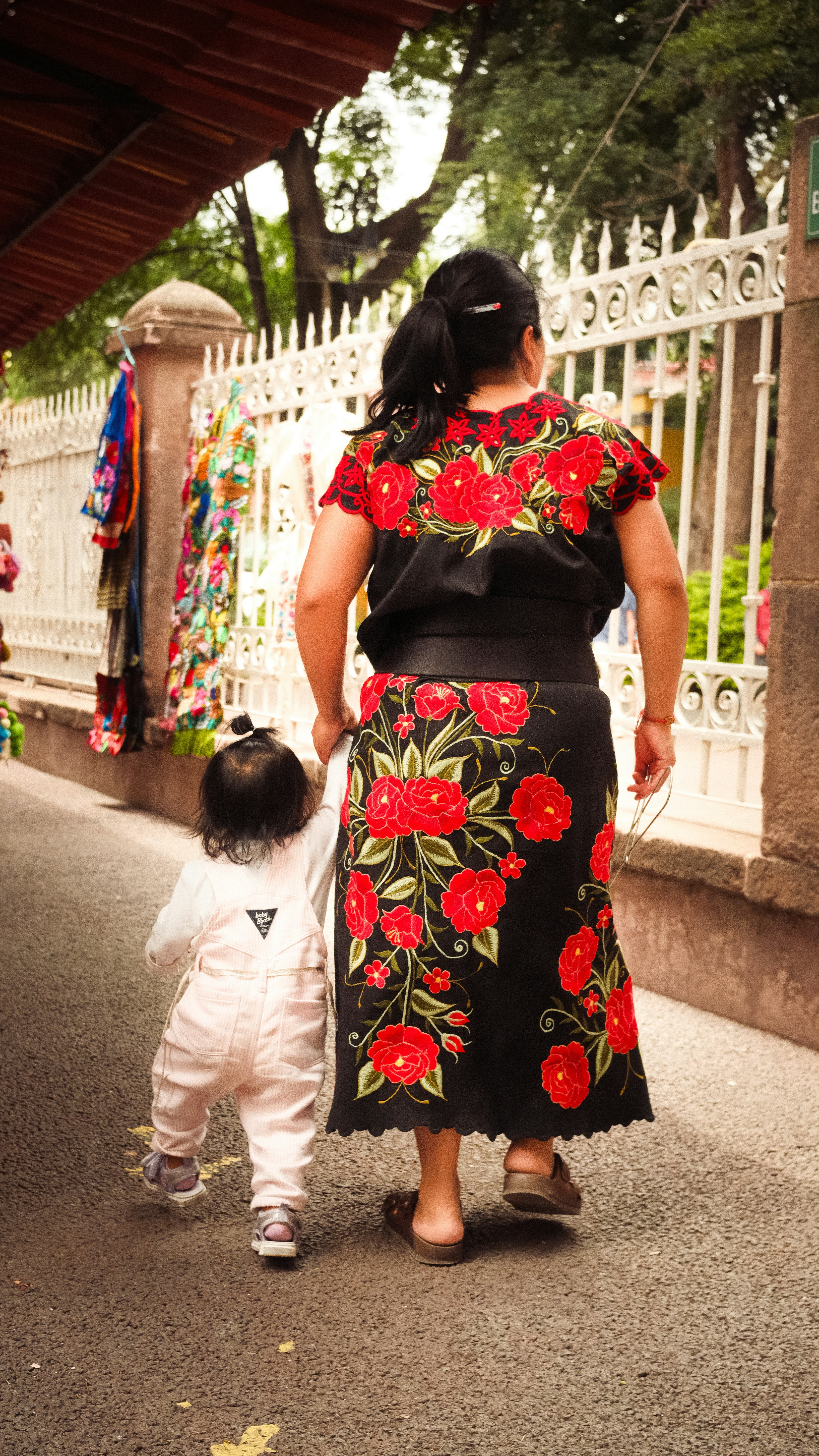 A woman and a child walking down a street