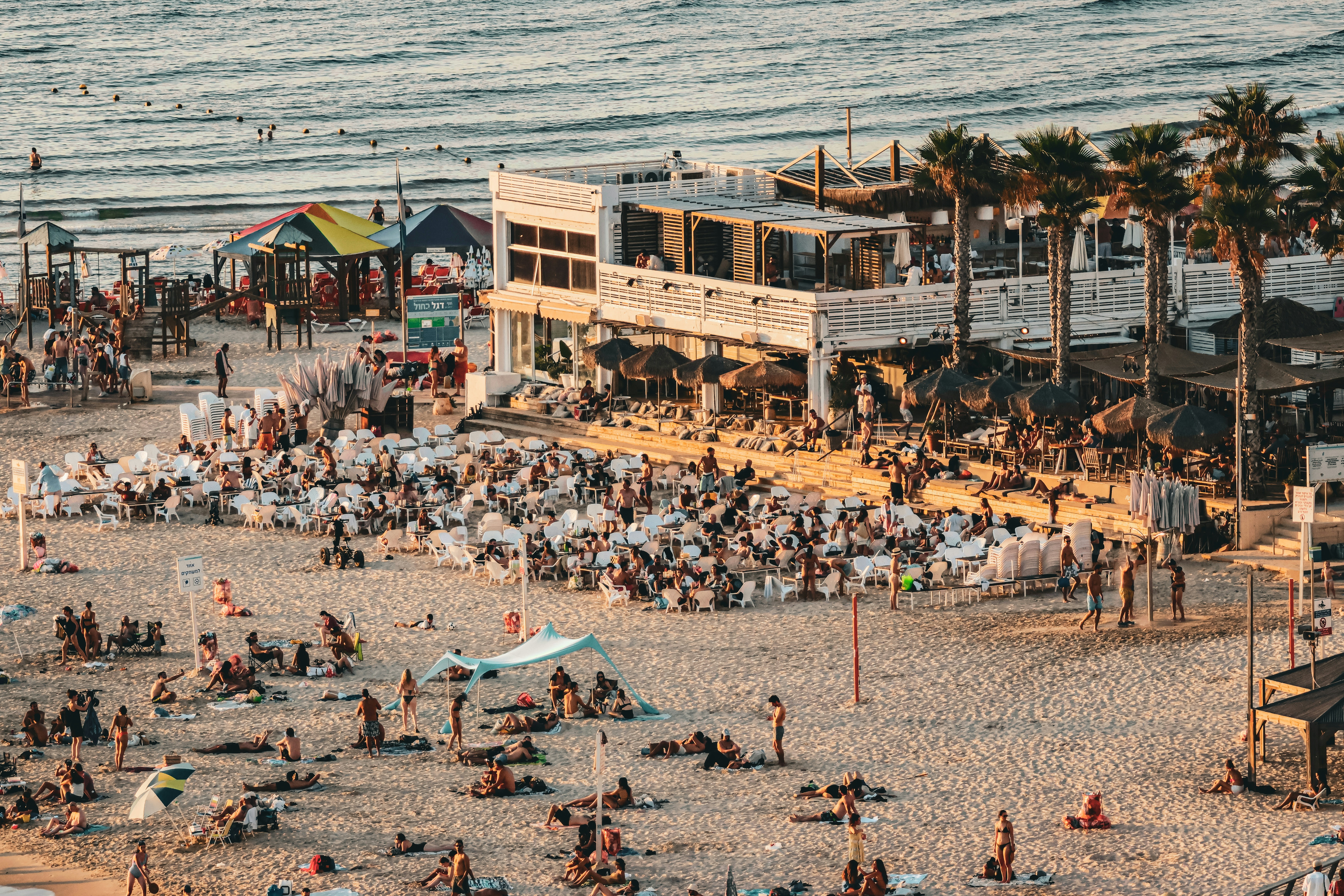A group of people on a beach next to the ocean