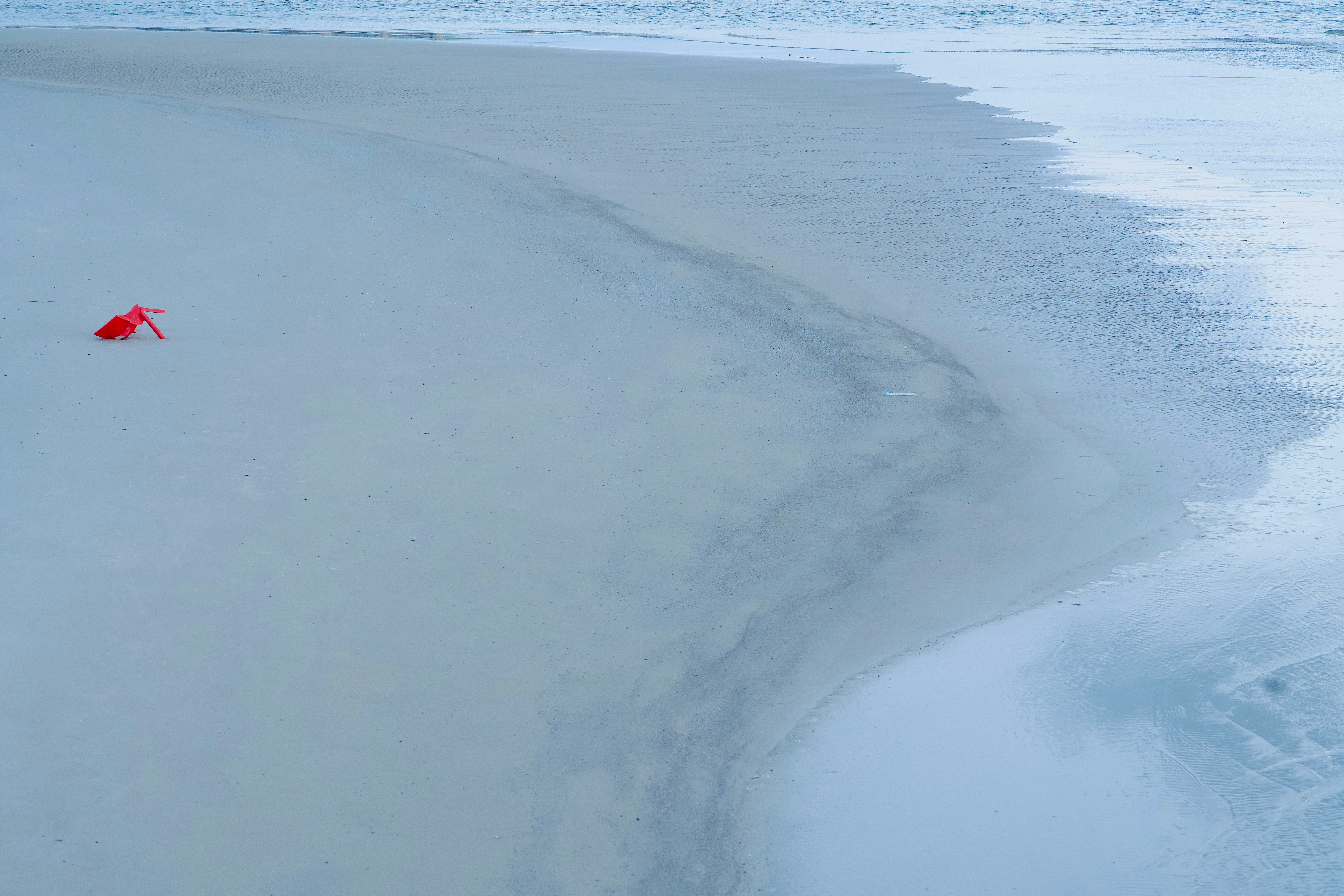 A red object in the middle of a snowy field