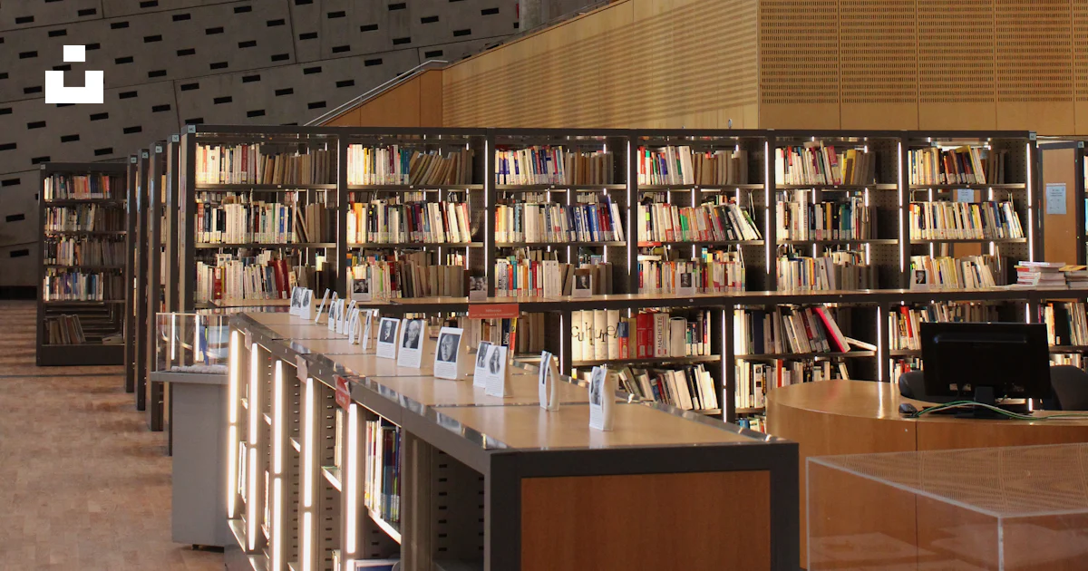 A library filled with lots of books under a roof photo – Free Building ...