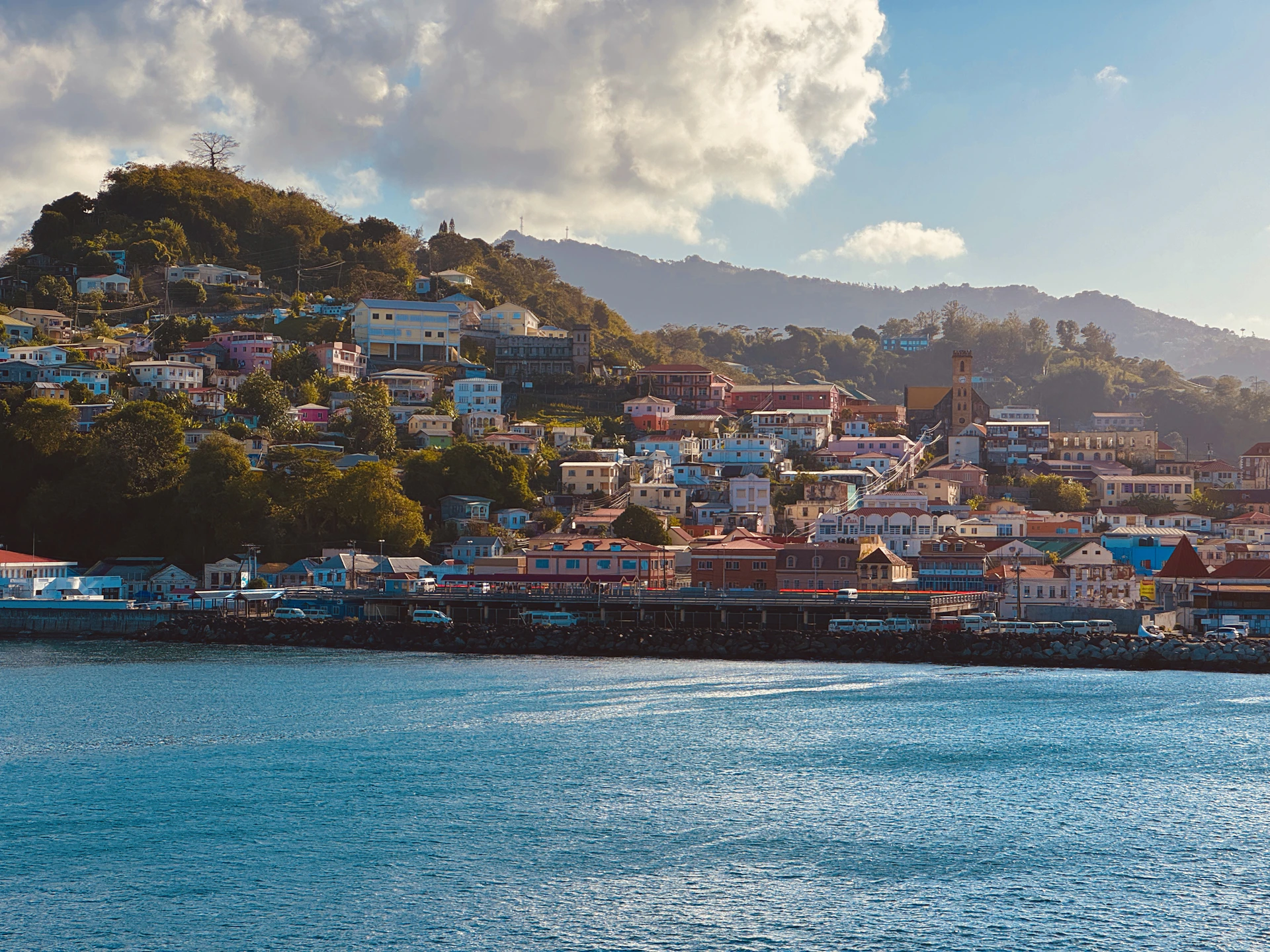 A view of a city on a hill above the water