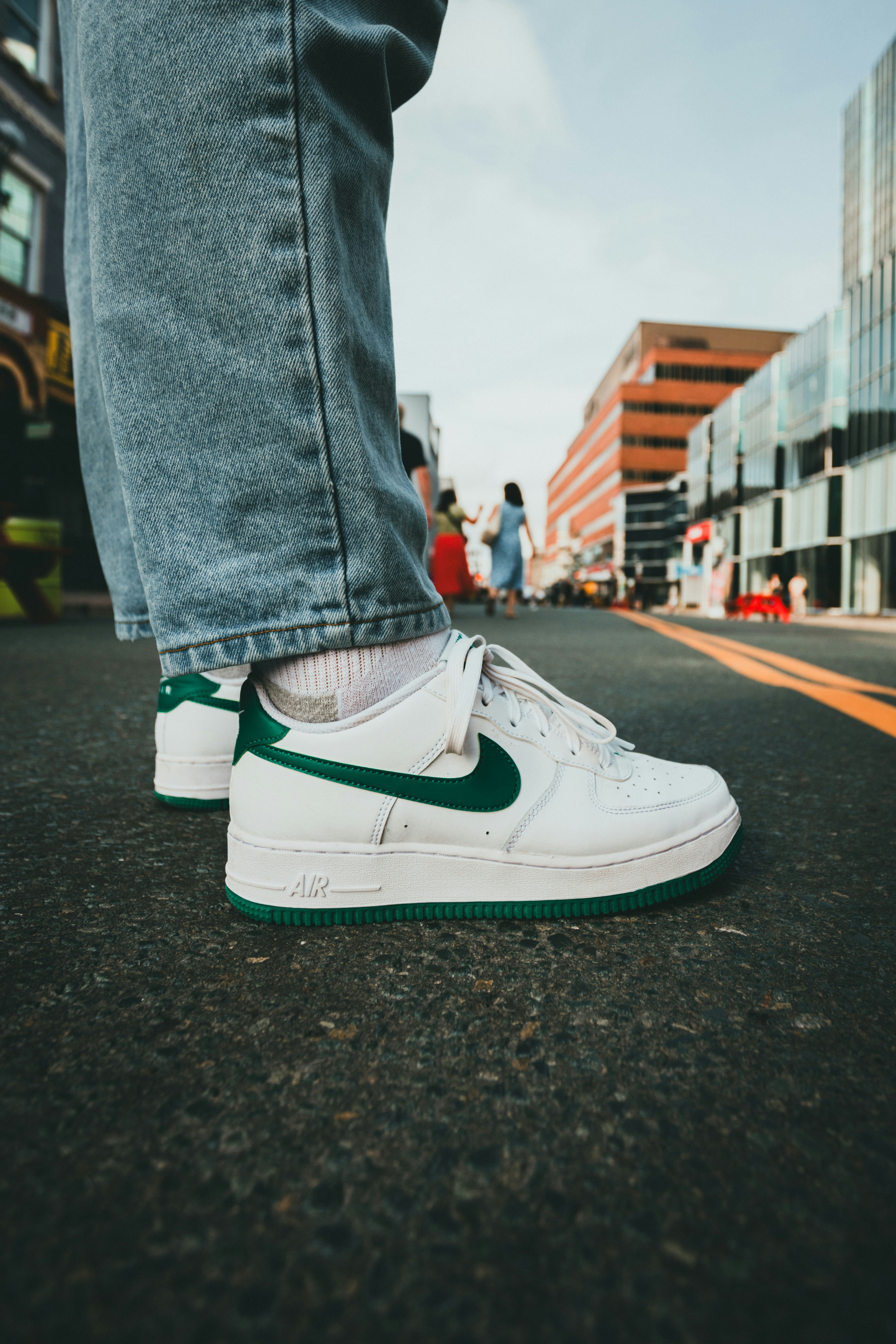 A person standing on a street with their feet on the ground