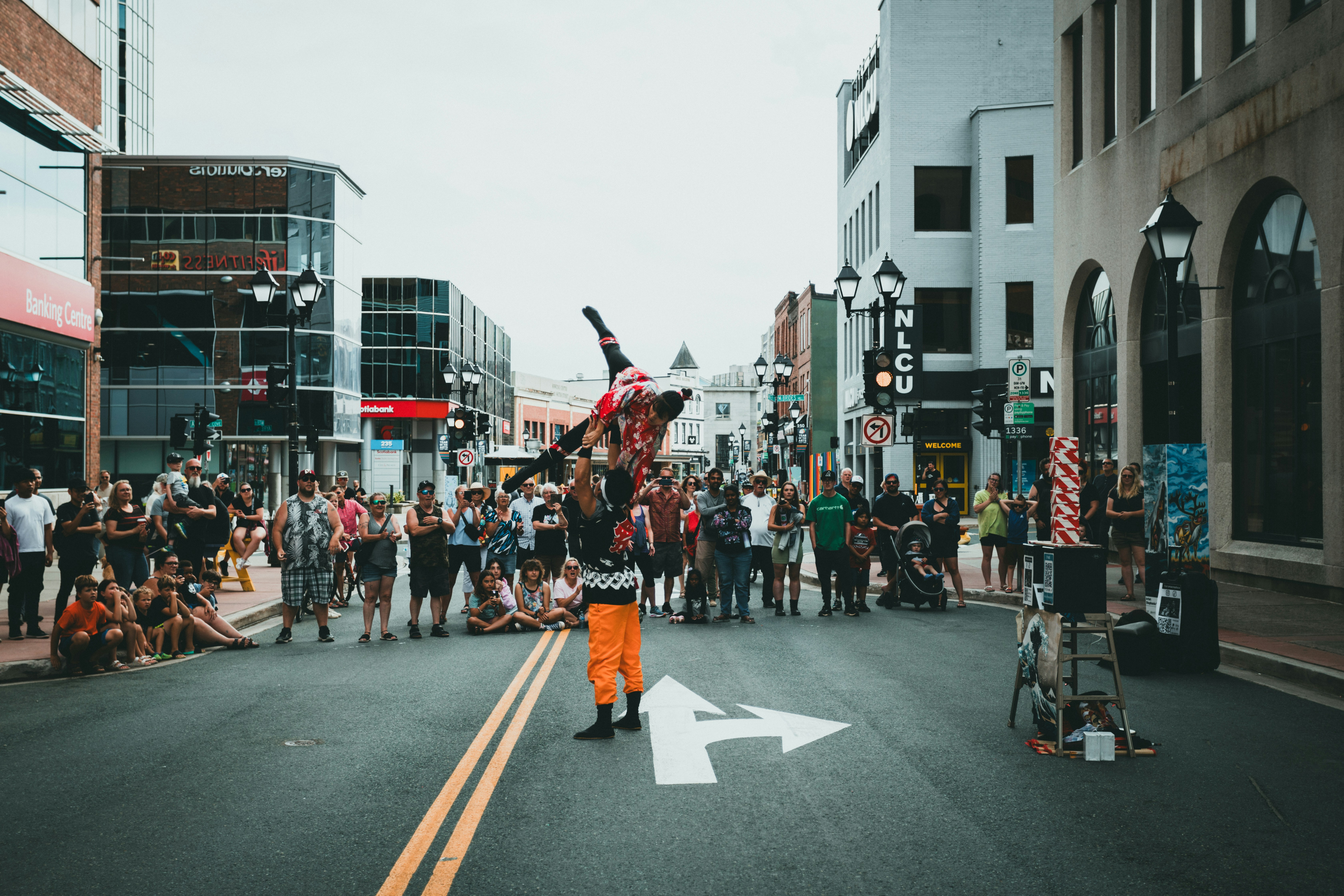 A group of people standing on the side of a road