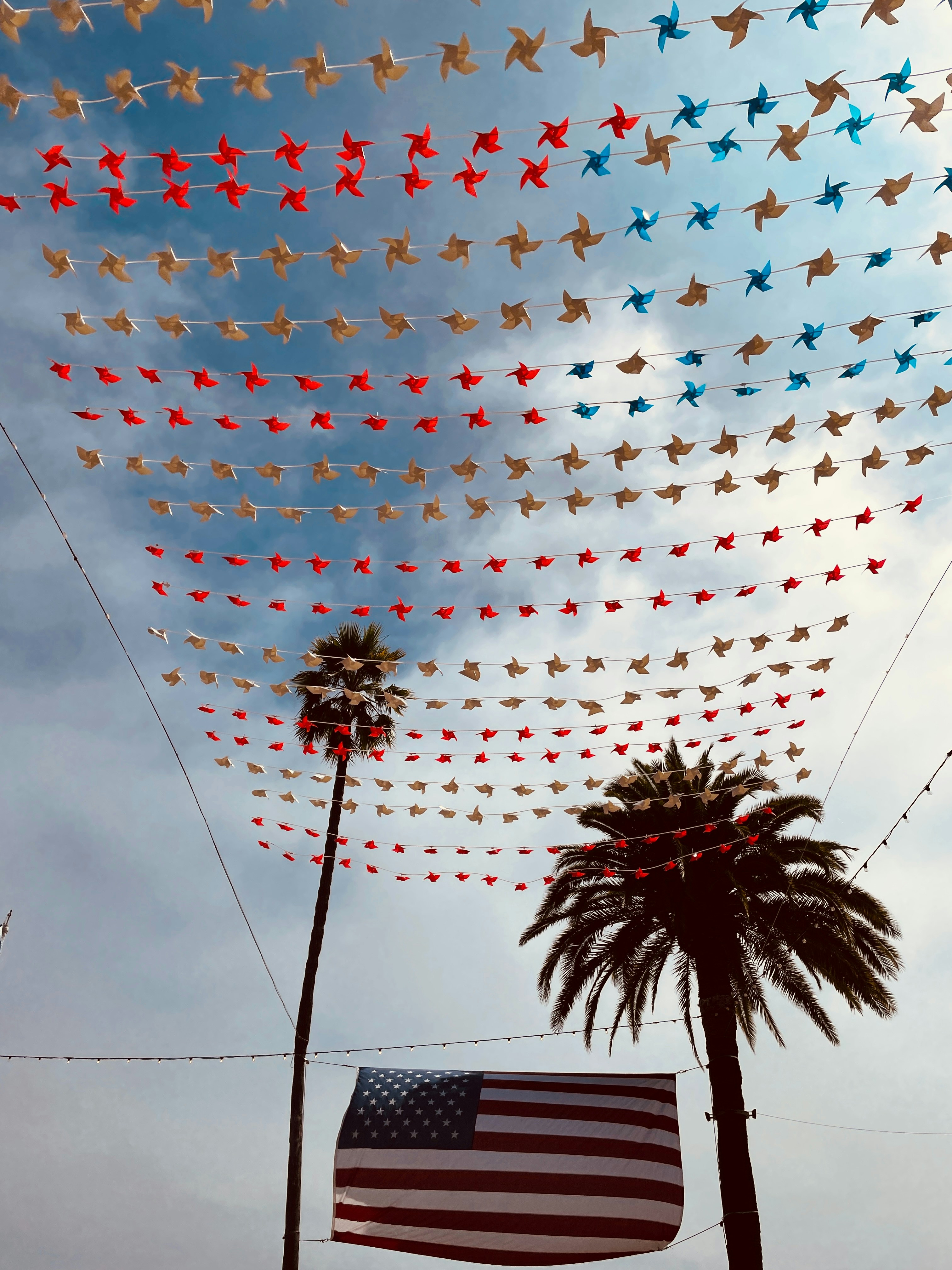 A large american flag is flying in the sky