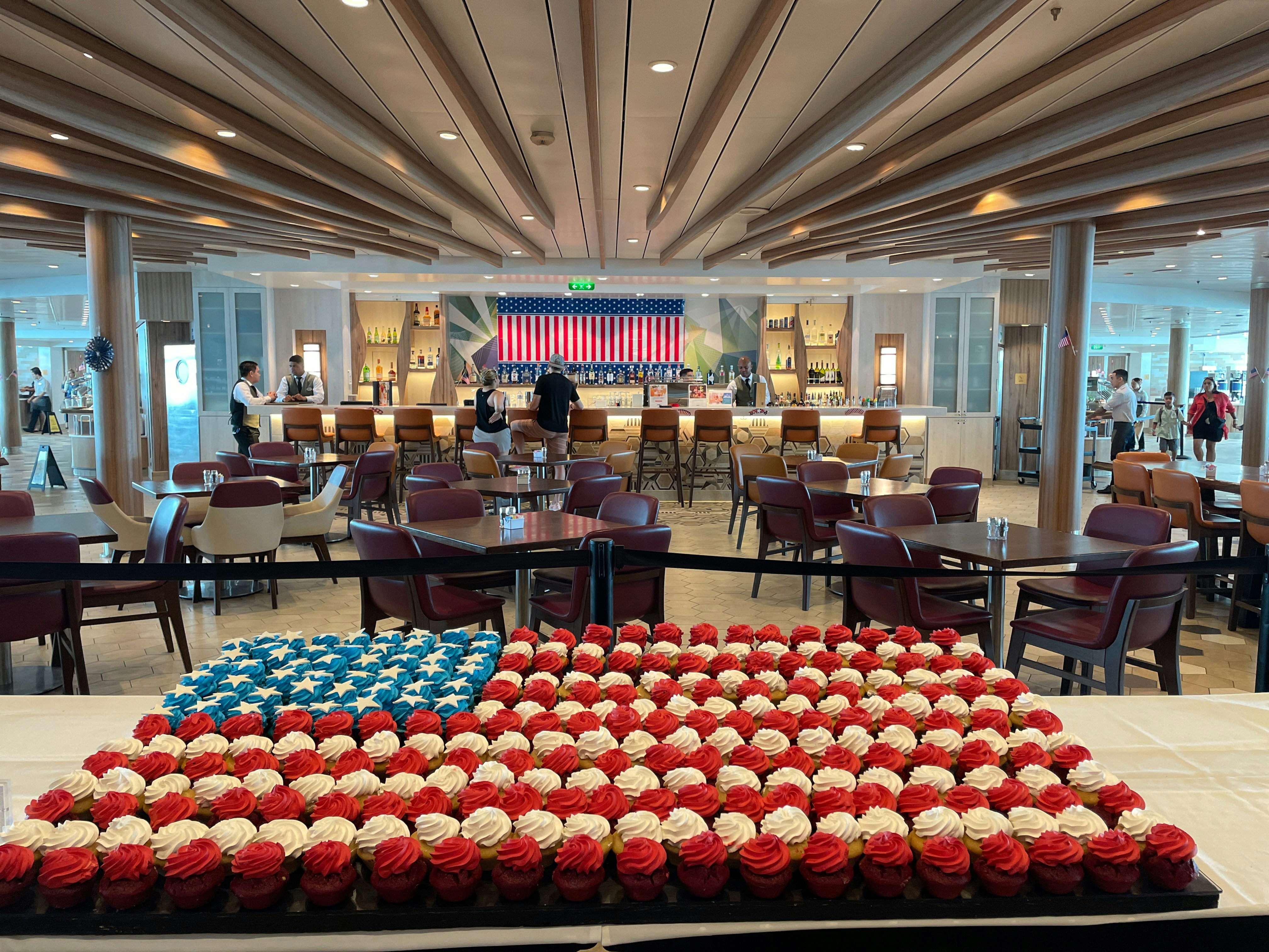 A large american flag made out of cupcakes