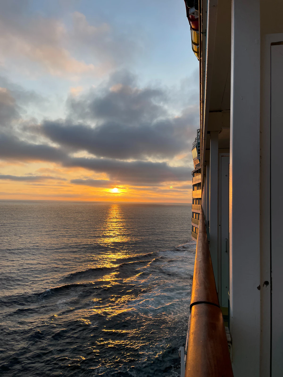 The sun setting over the sea, seen from a cruise ship’s balcony