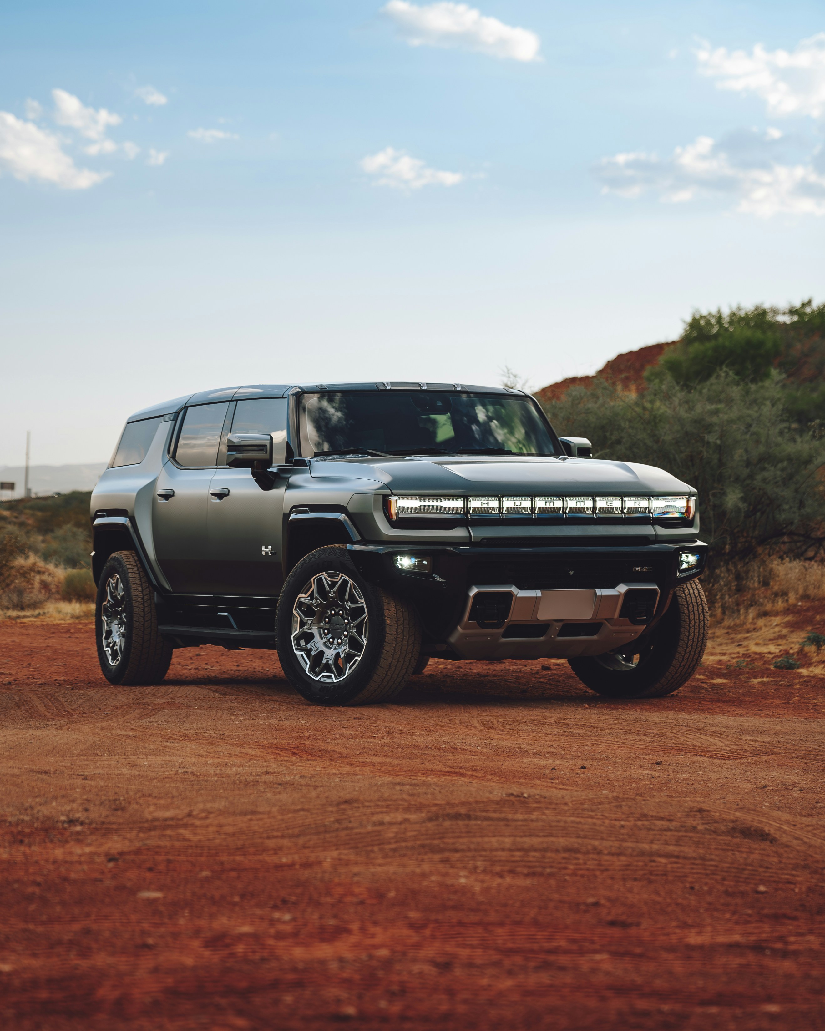 A silver truck parked on a dirt road