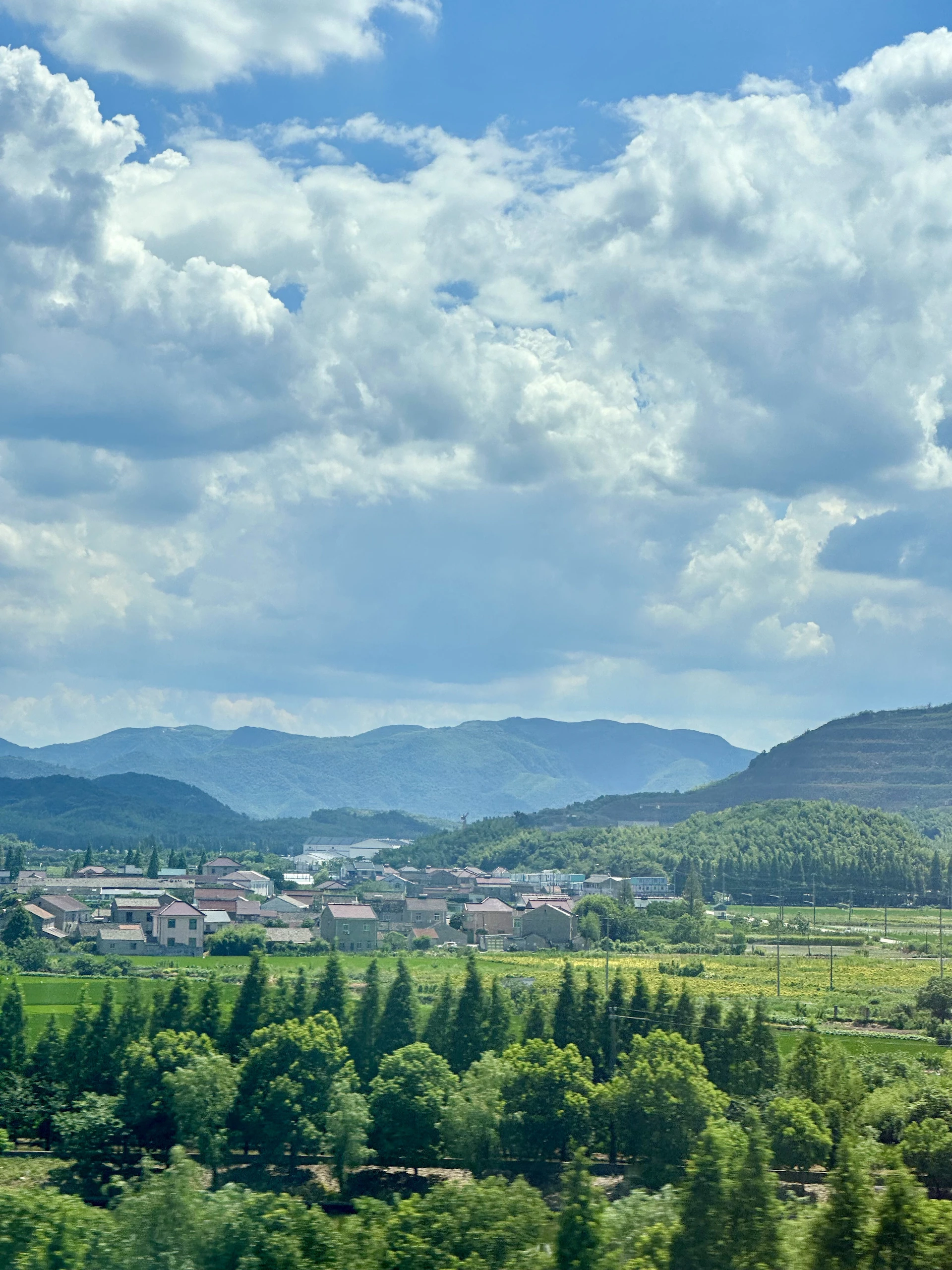 A scenic view of a town and mountains in the distance