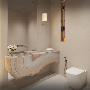 A white toilet sitting next to a white sink in a bathroom