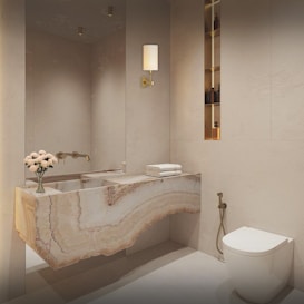 A white toilet sitting next to a white sink in a bathroom