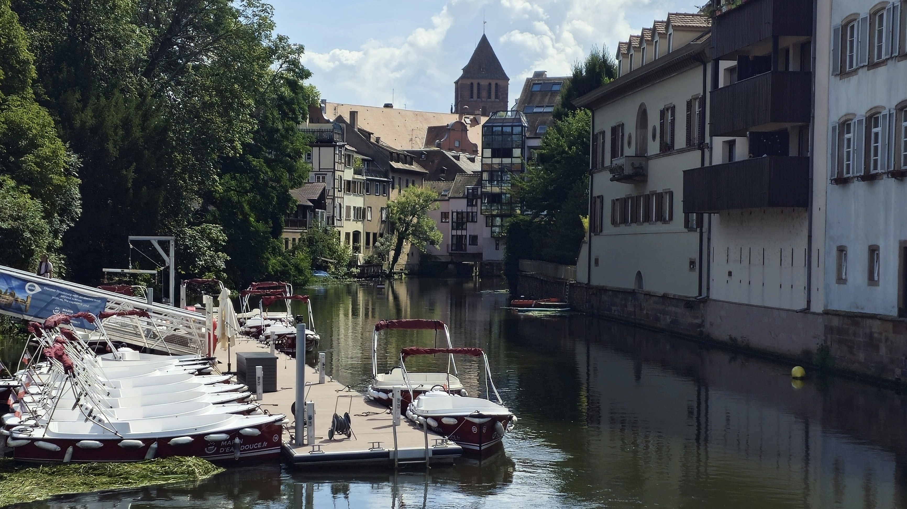 A river running through a city next to tall buildings