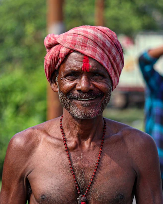A man in a turban smiles for the camera