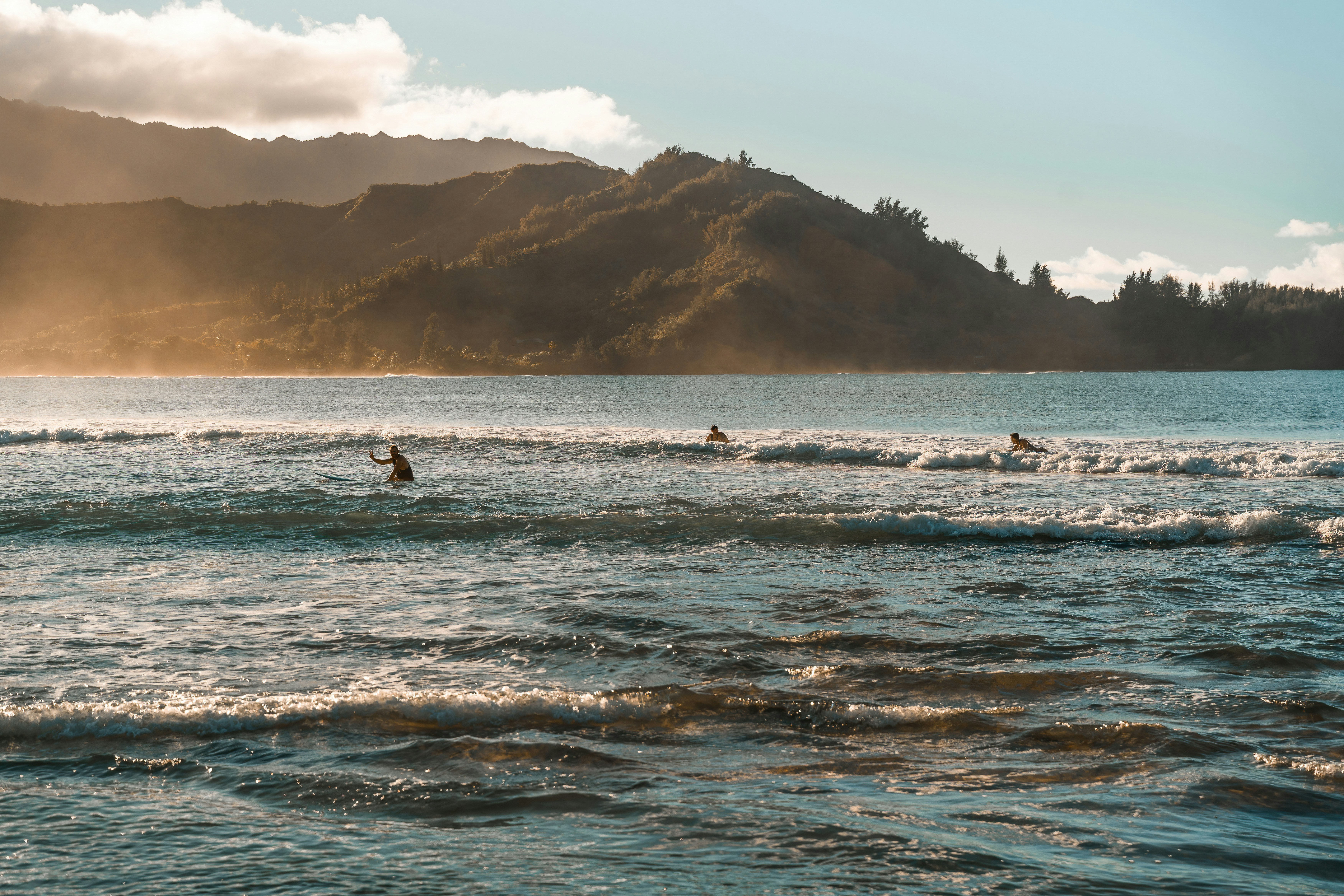 A group of people riding surfboards on top of a body of water
