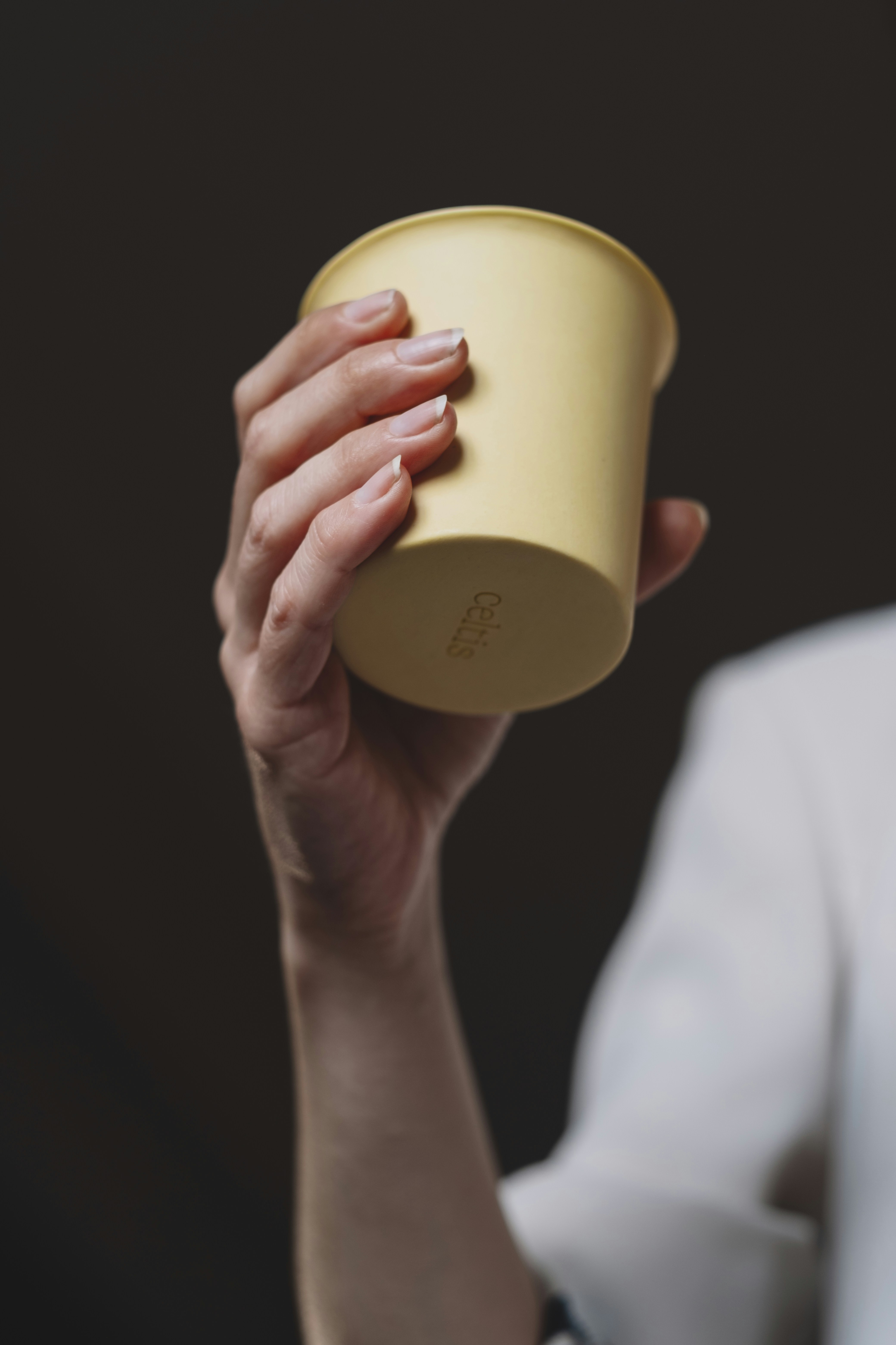 A woman holding a cup in her hand