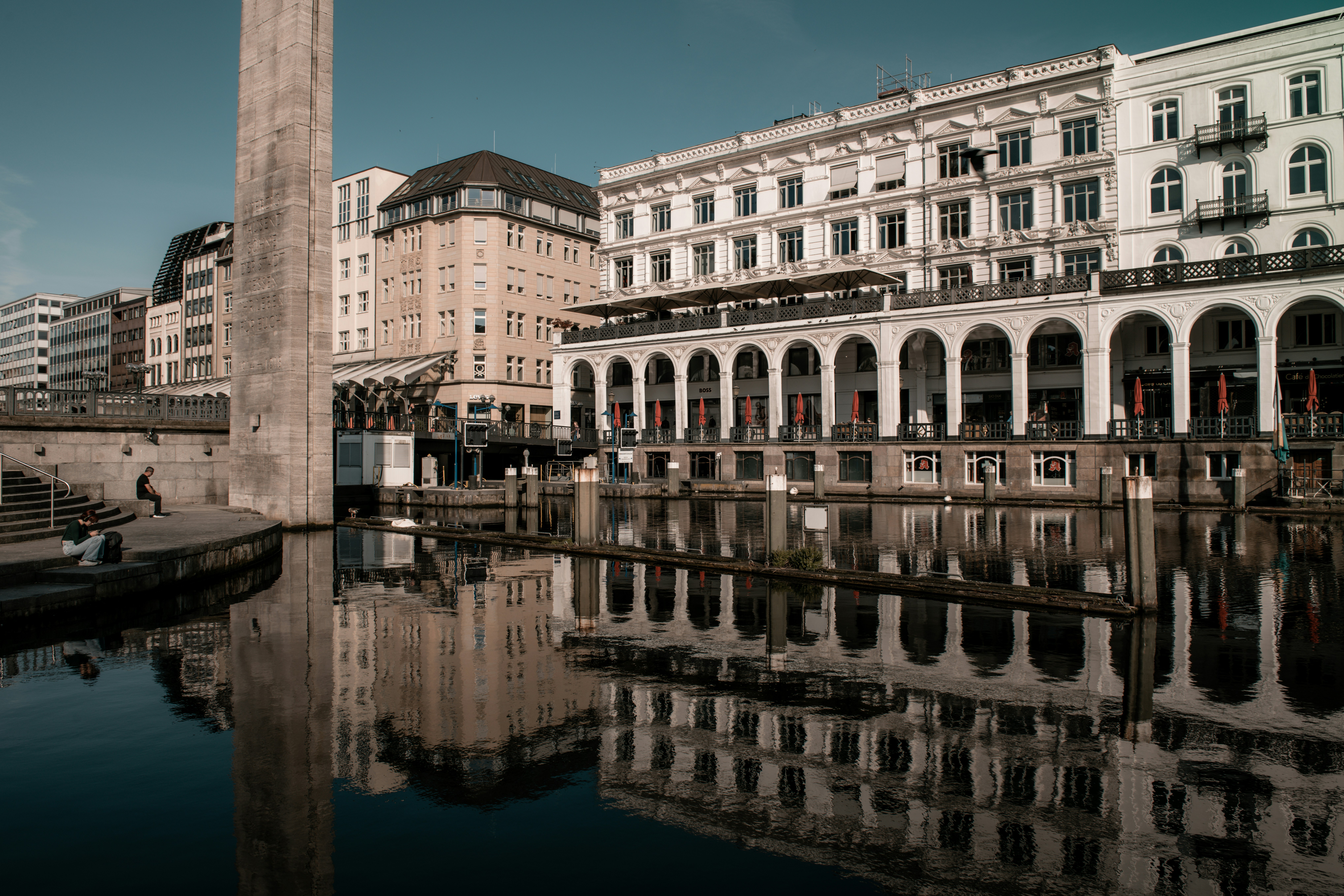 A tall clock tower sitting next to a body of water
