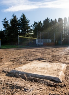A baseball field with a base in the dirt