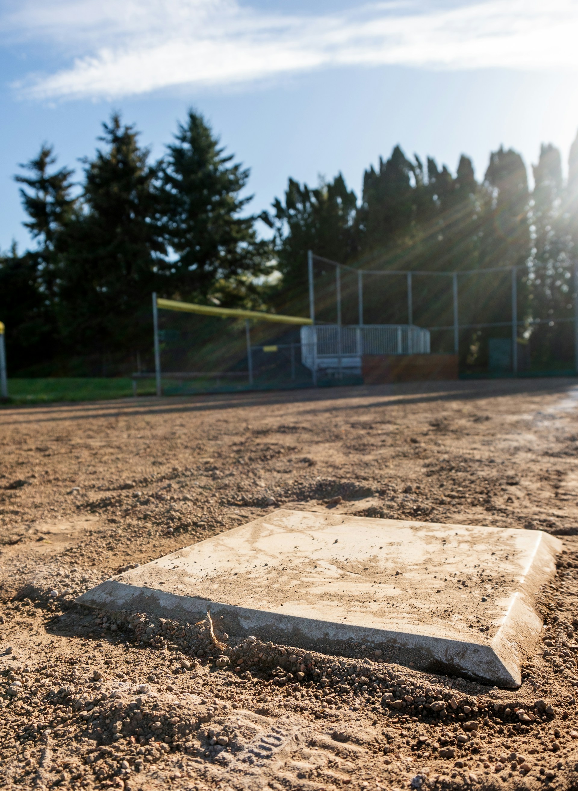 A baseball field with a base in the dirt