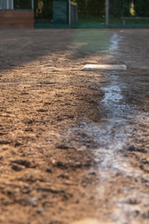A baseball field with a base on the ground