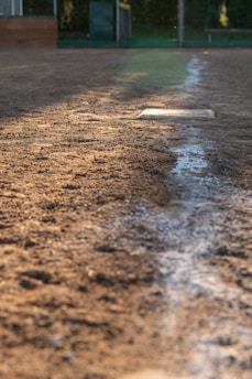 A baseball field with a base on the ground