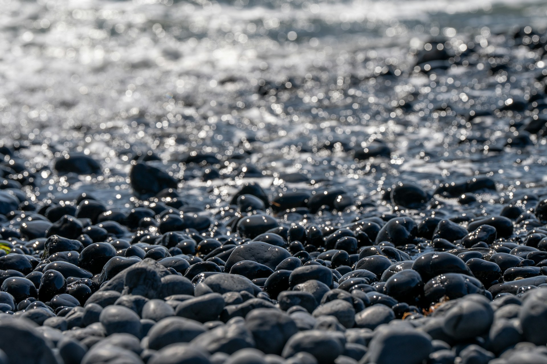A close up of rocks and water on a beach