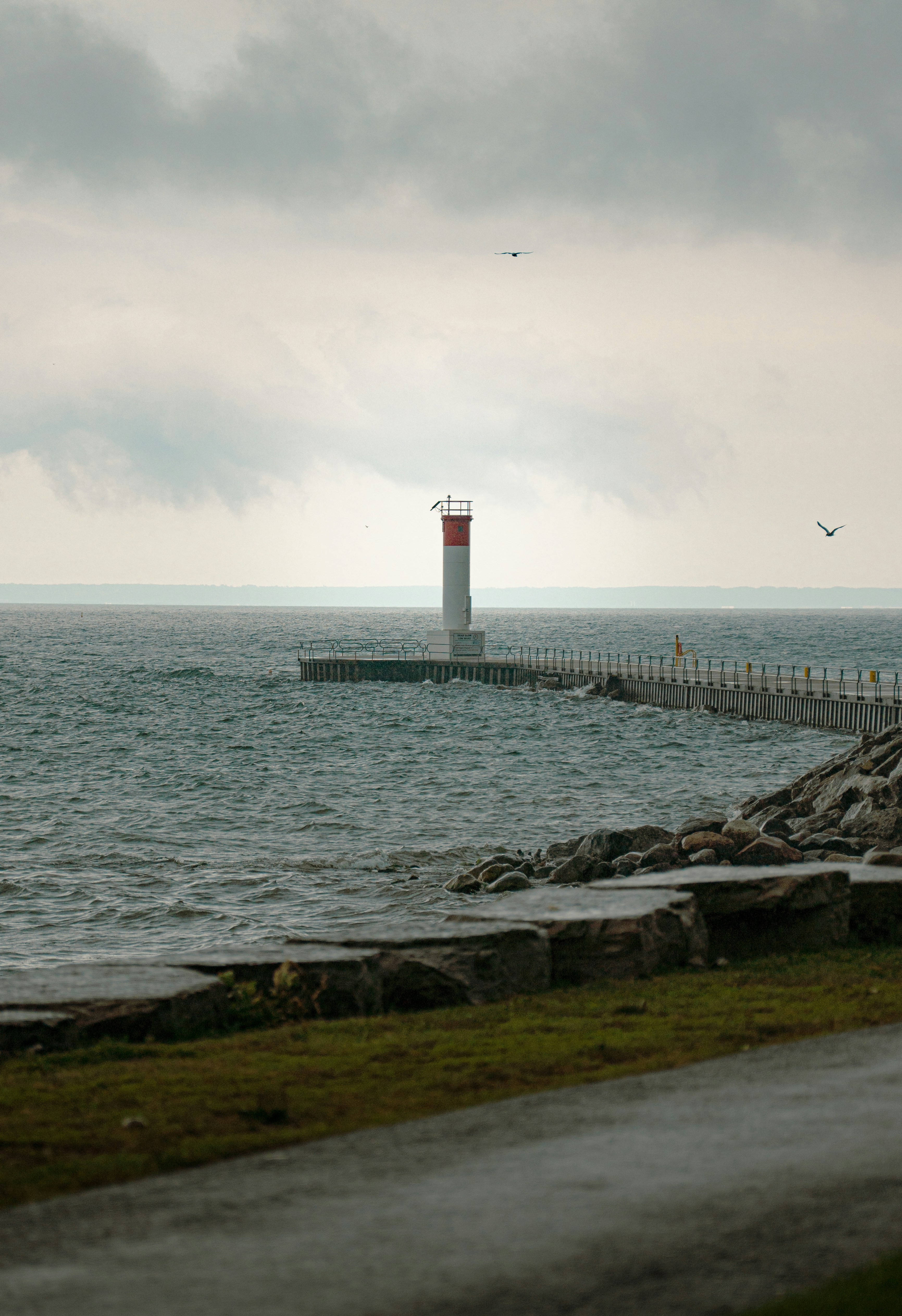 A lighthouse on the shore of a body of water