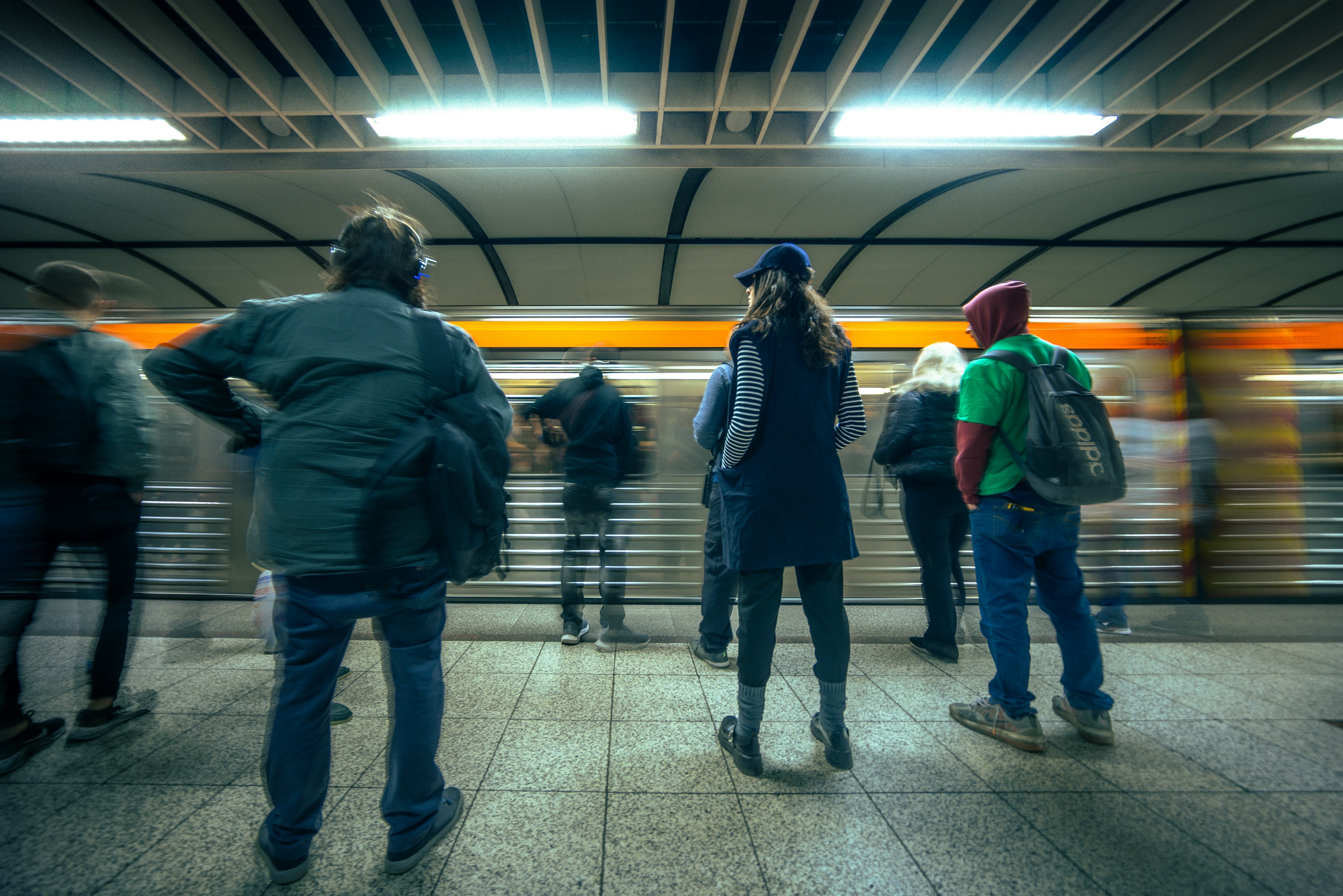A group of people standing in a train station