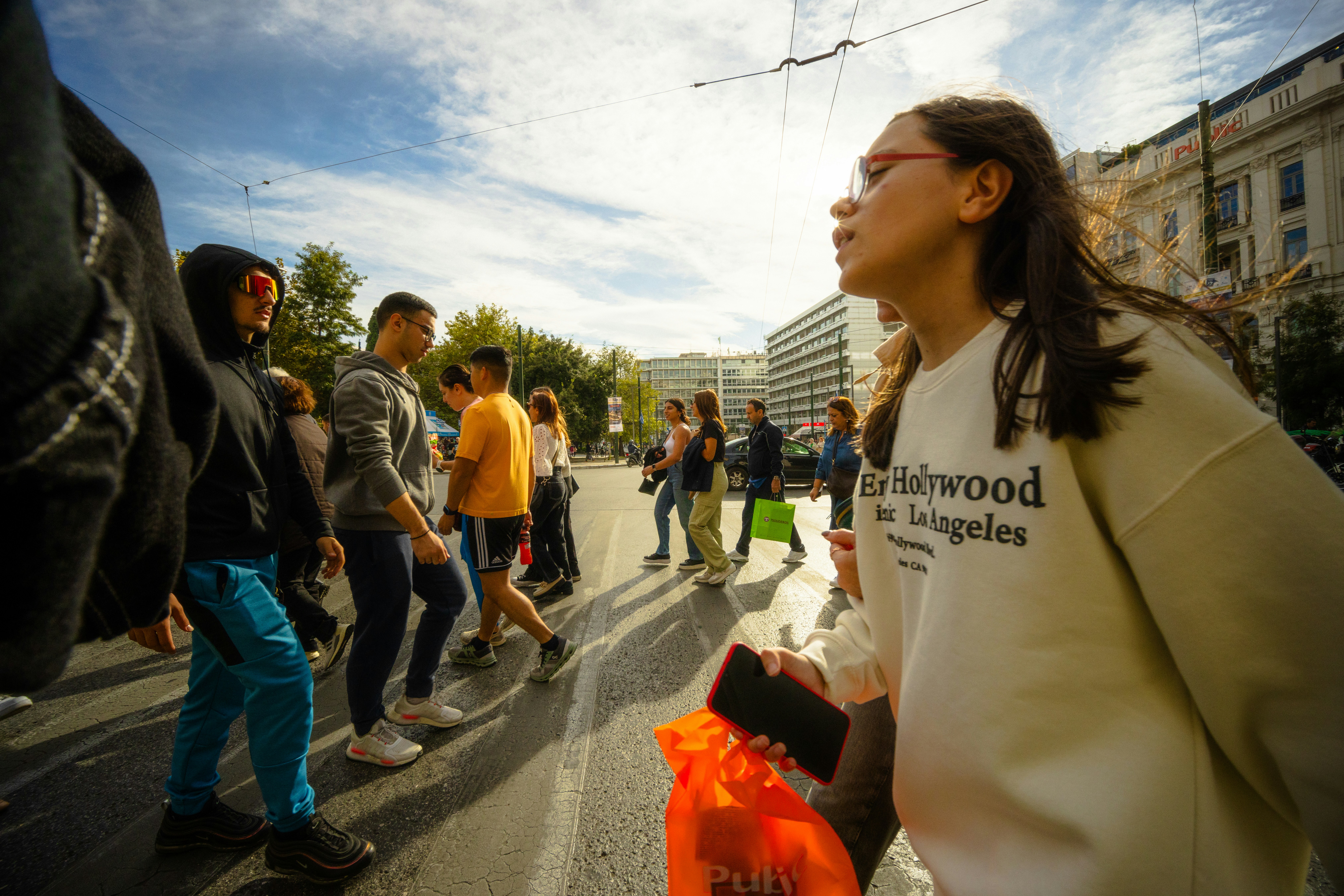 A group of people walking down a street