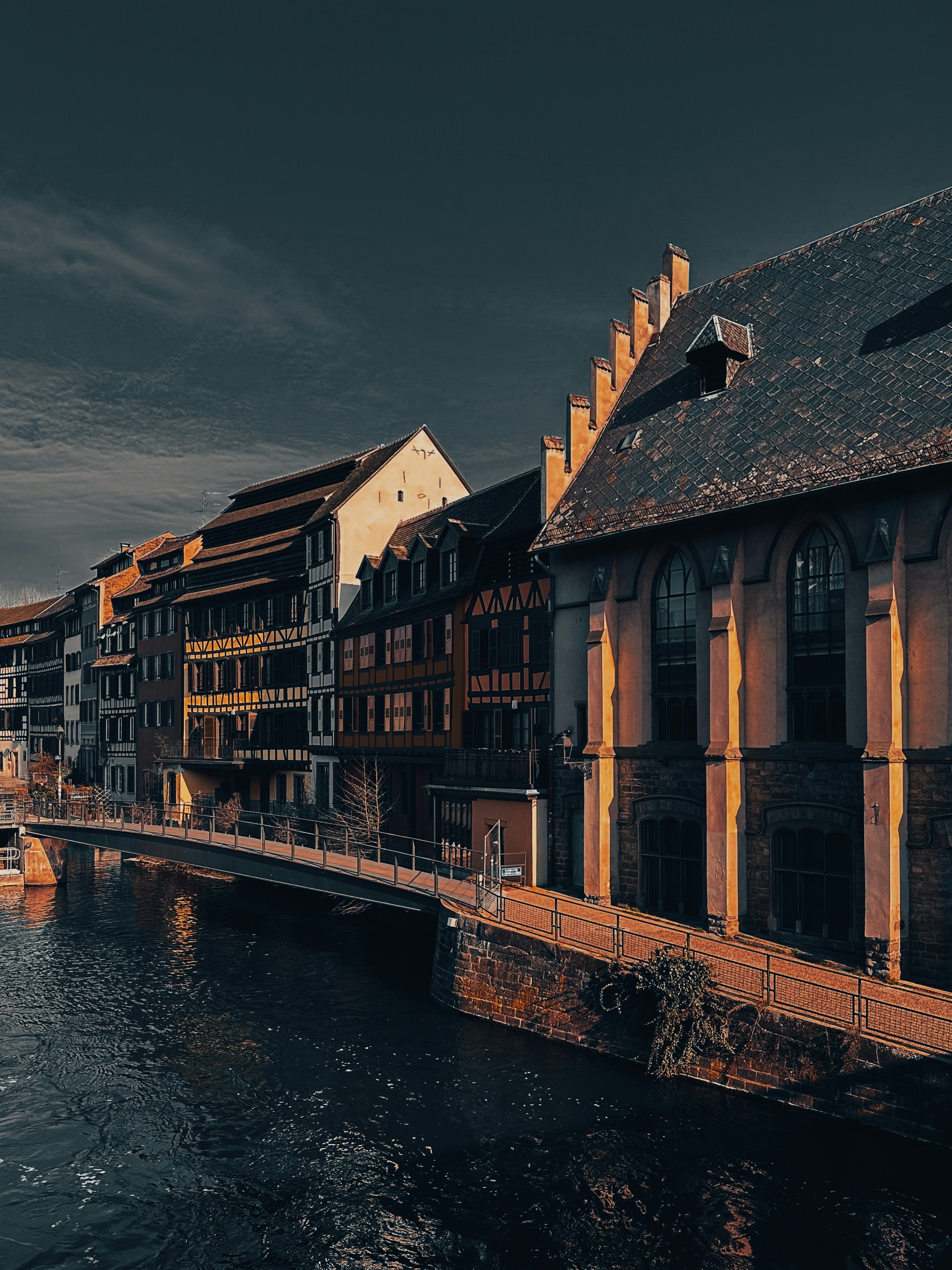 A river running through a city next to tall buildings
