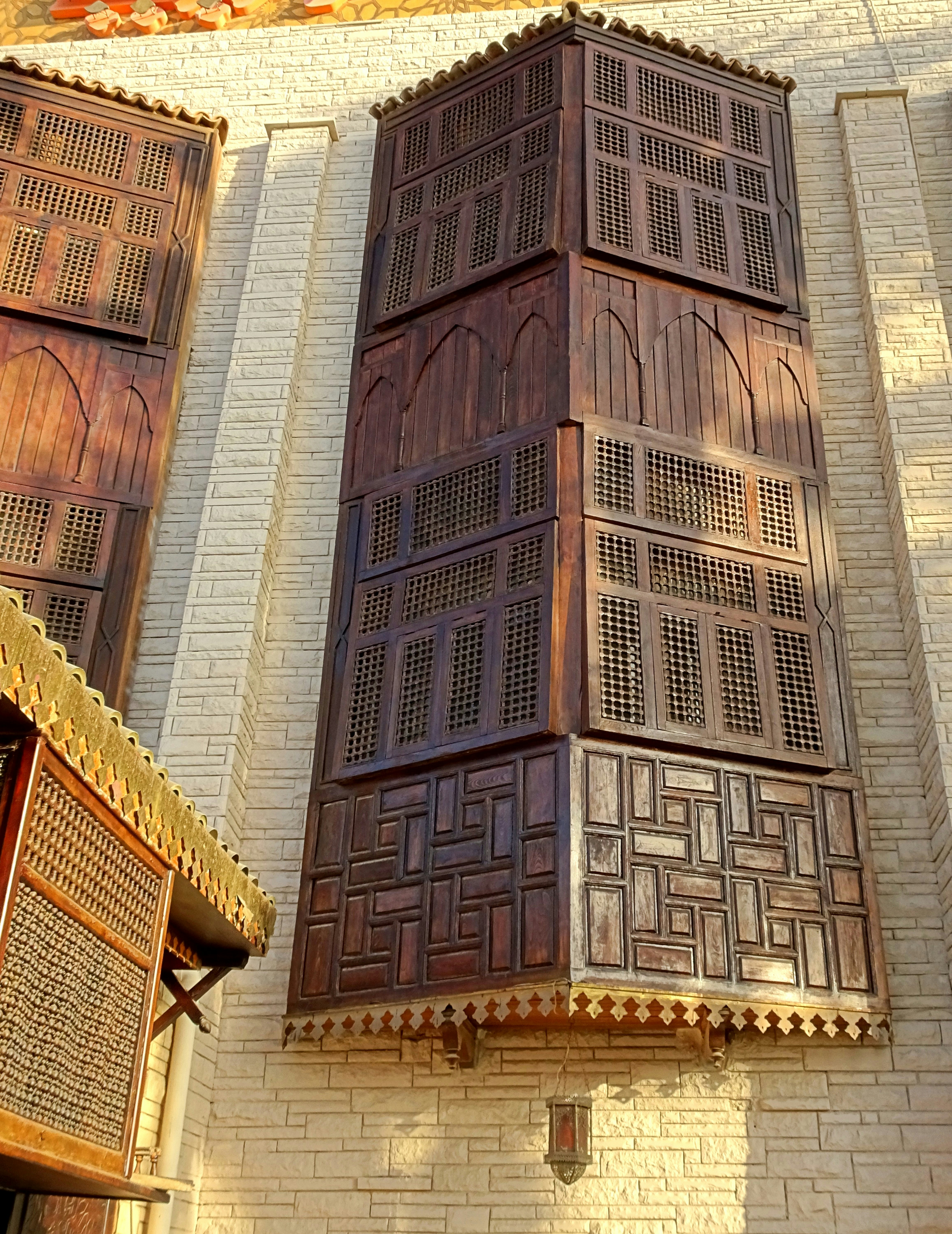 A tall wooden building with a clock on it's side