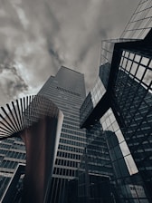 A group of tall buildings with a cloudy sky in the background