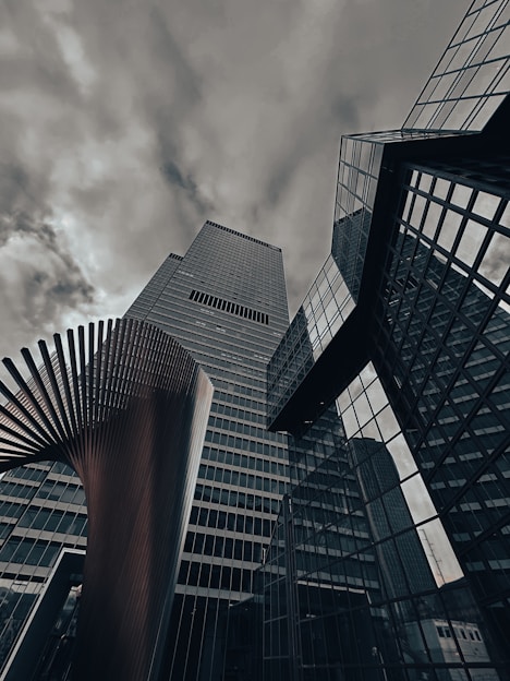 A group of tall buildings with a cloudy sky in the background