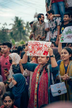 A group of people holding up signs in the air