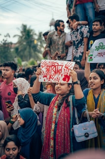 A group of people holding up signs in the air