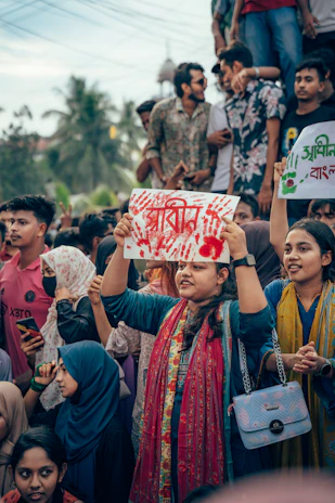 A group of people holding up signs in the air