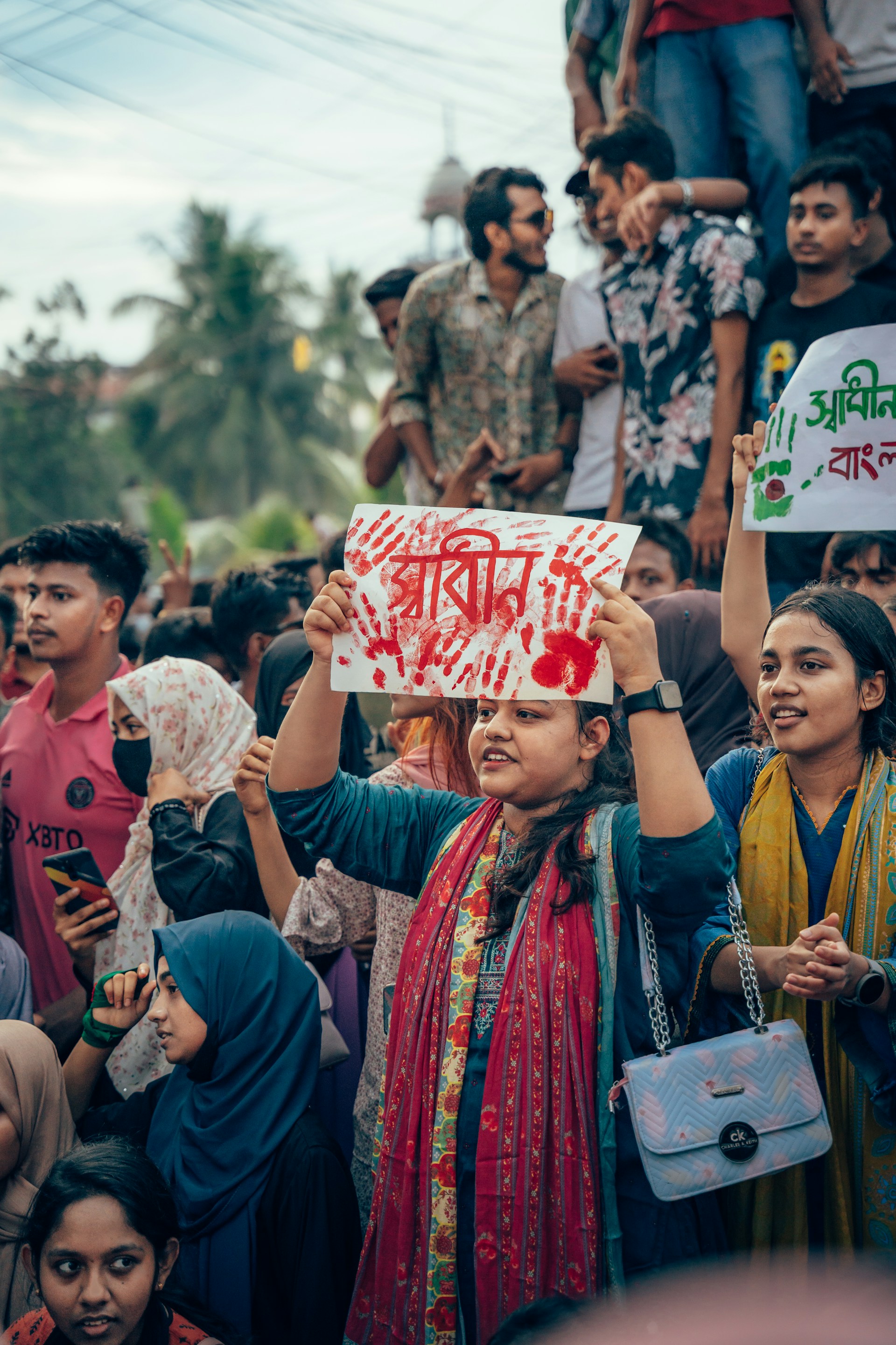 A group of people holding up signs in the air